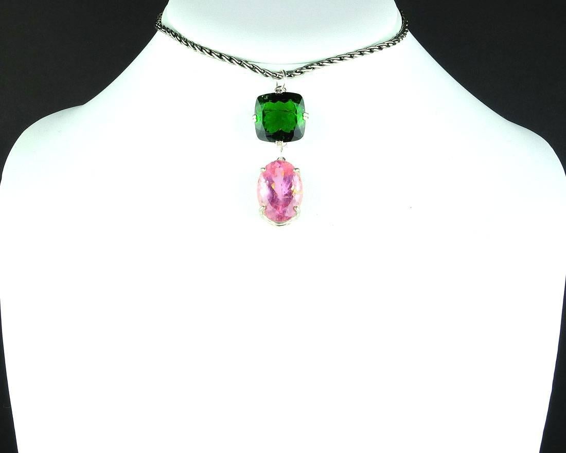 Glittering natural oval cut 15.5 carat pink Tourmaline (19 mm x 13.4 mm) complemented by a huge brilliant natural cushion cut 15.67 Carat green Tourmaline  (15.87 mm x 15.57 mm) set in a sterling silver pendant that hangs 1.5 inches long.  The chain