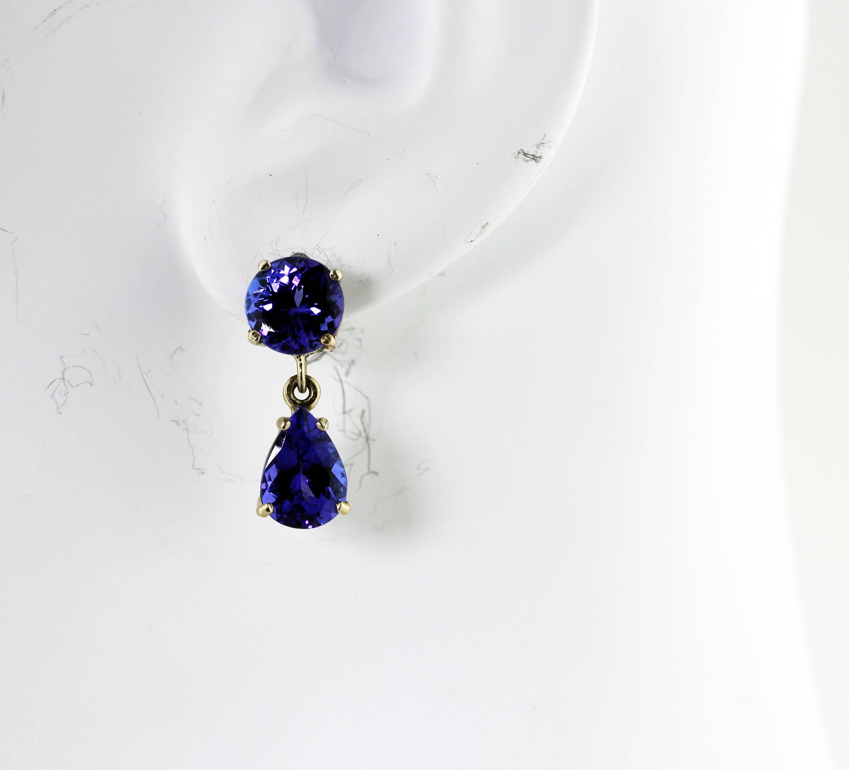 Brilliant unique AAAA quality sparkling 2 carats each of pear cut blue Tanzanites swing gracefully from the 1.78 carats each of round glittering AAAA quality blue Tanzanites set in handmade white gold stud earrings.   They dangle .82 inch from top