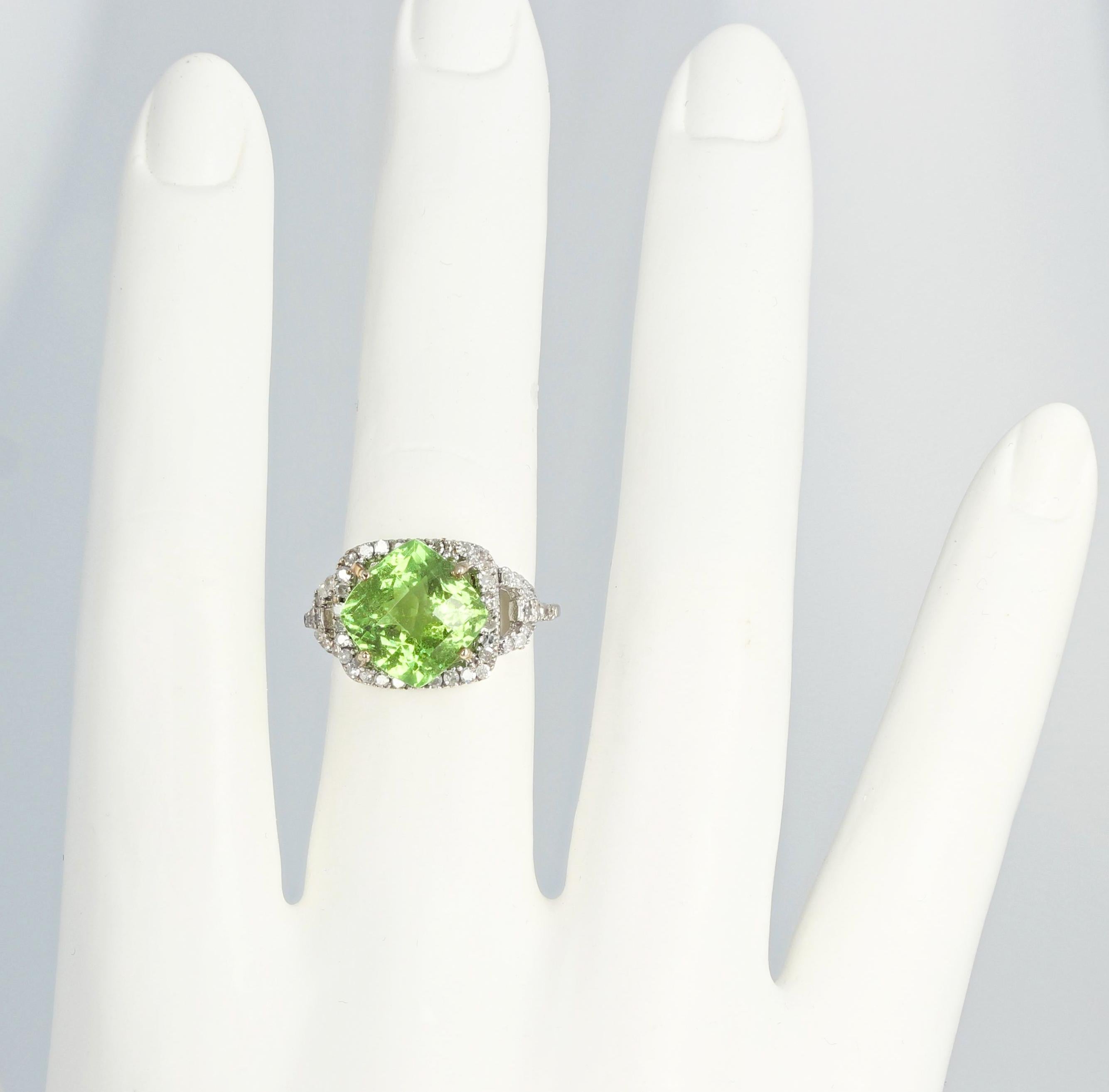 Glittering brilliant clear checkerboard cushion cut 4.5 carat green Tourmaline (10 mm x 10 mm) set in a unique 10kt white gold ring enhanced with .40 carats of White Diamonds.  The ring is a size 7 (sizable FOR FREE).  