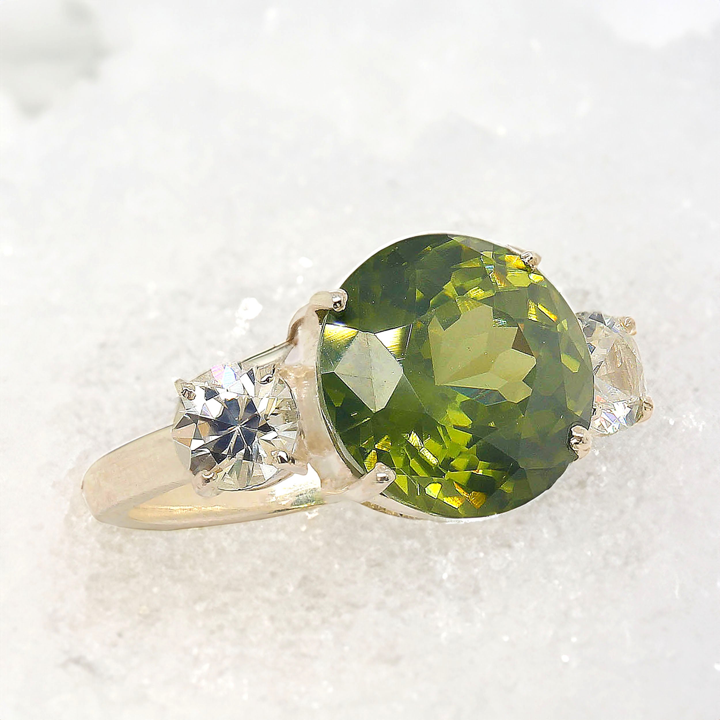 Cocktails will never look the same as you raise your glass!  This sophisticated green and white genuine Zircon Cocktail ring is a show stopper.  The gorgeous round 7.51 carat  green Zircon is enhanced with round white sides stones total 1.47 carats.