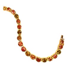 AJD Mehrfarbiges Turmalin 'Tennis-Armband' und 18 Karat Gelbgold-Armband