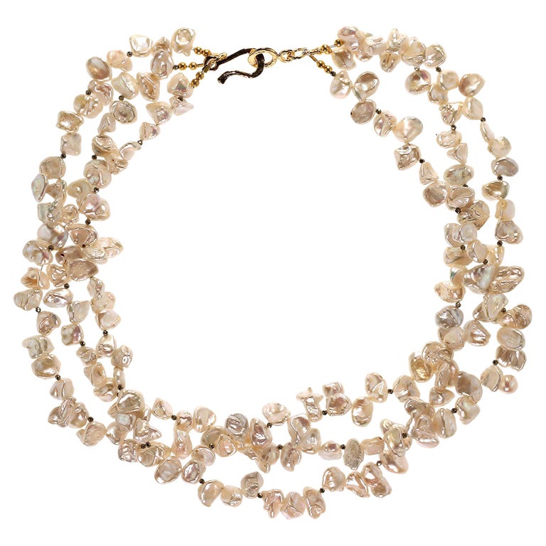 Own the pearls you deserve

Luscious three strand necklace of iridescent white Biwa Pearls with Pyrite accents. This versatile 19 inch necklace can be worn flat or twisted for a shorter look. The faceted Pyrite add a bit of sass and sparkle to this