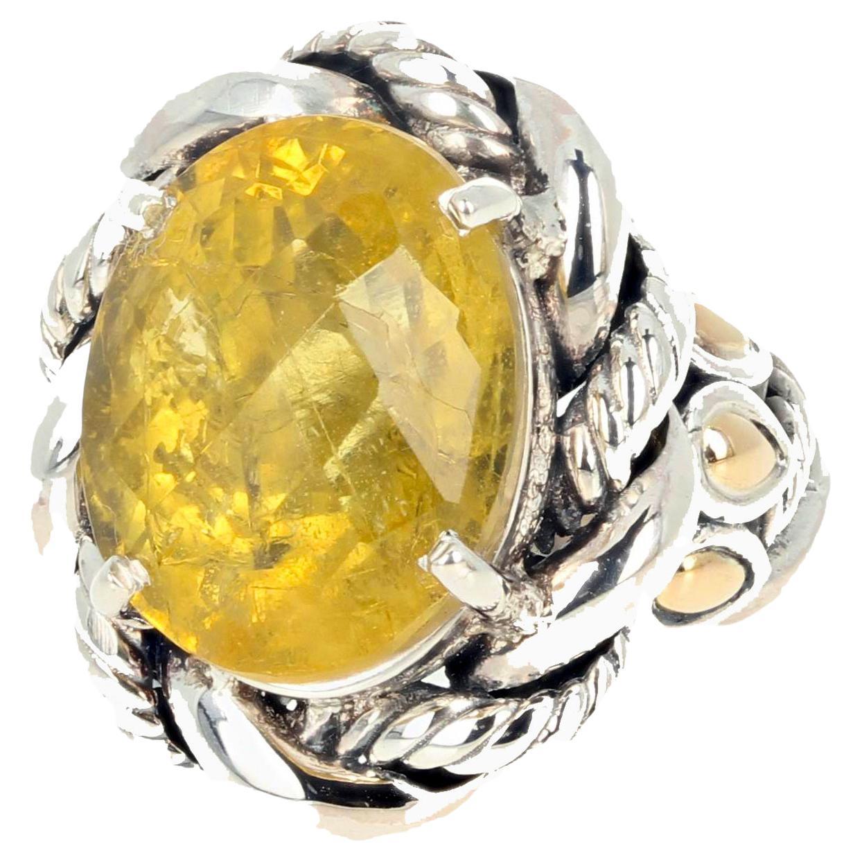This fascinating ring is 6.84 carats of foggy but glittery natural checkerboard gem cut oval yellow Beryl.  The flecks of inclusions in this gemstone are what makes it so beautiful and different.  This is sterling silver with goldy tear drops down