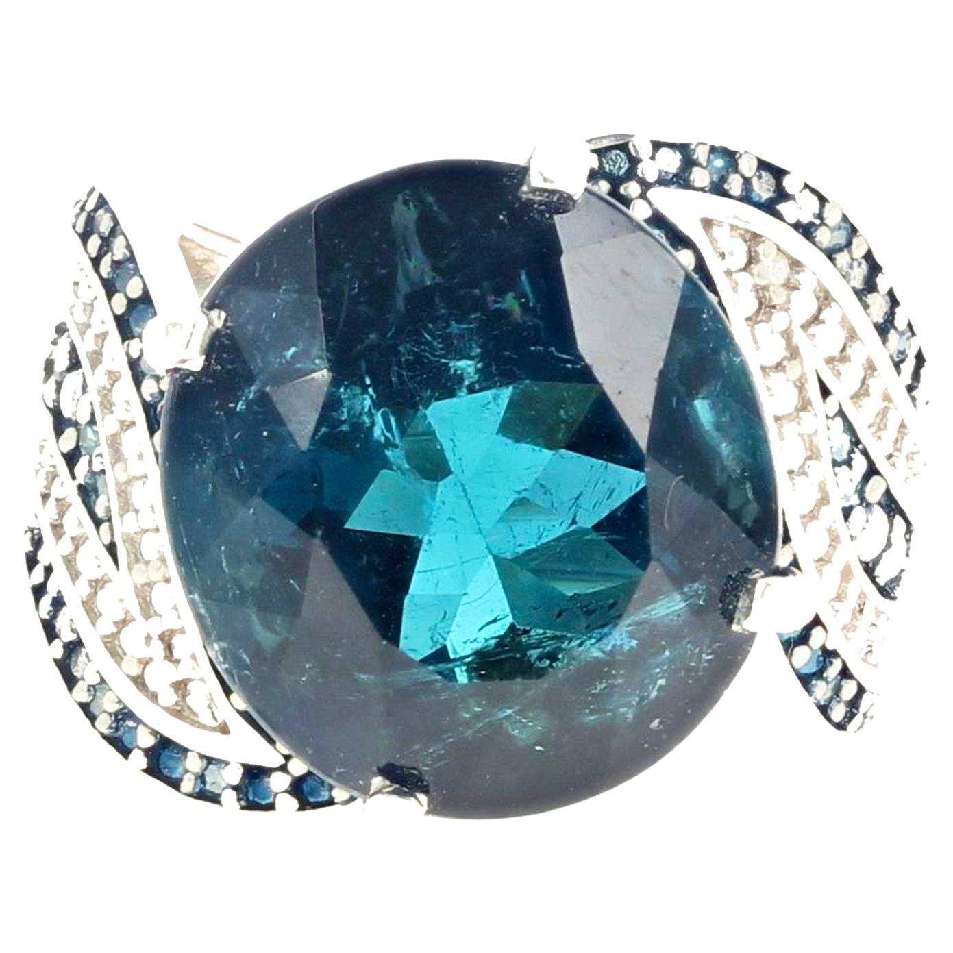 This magnificent super-elegant 17.7 carat natural Indicolite (Blue) Tourmaline is 17mm x 15.4mm enhanced with very dark blue and white tiny little diamonds set in a sterling silver rhodium plated ring size 8 sizable (we size for free).  It is