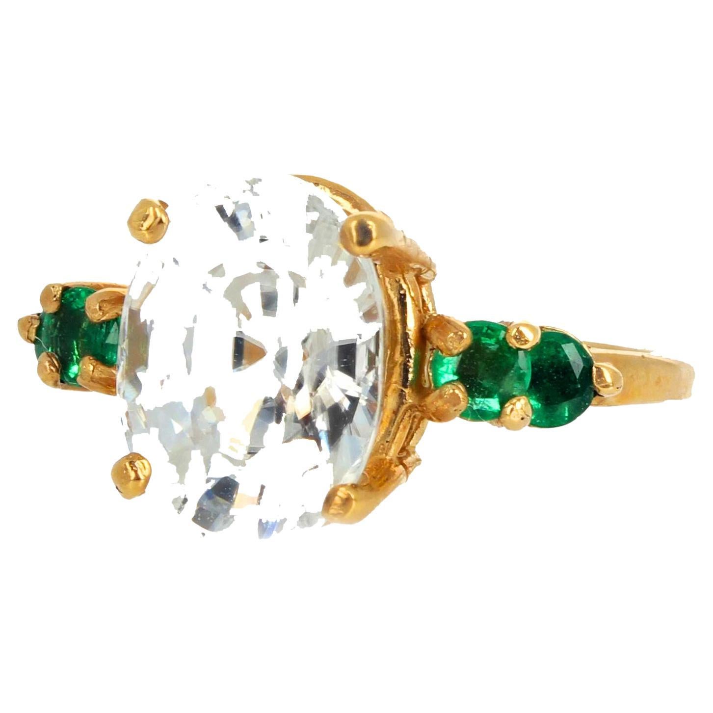 Brilliant 4 carat natural White Zircon (11.5 mm x 8.5 mm) enhanced with 4 glittering natural green emeralds (approximately 0.48 carats - 3.2mm each) set in this lovely 10K yellow gold ring size 7 (sizable for free).  Look at all the photos to see