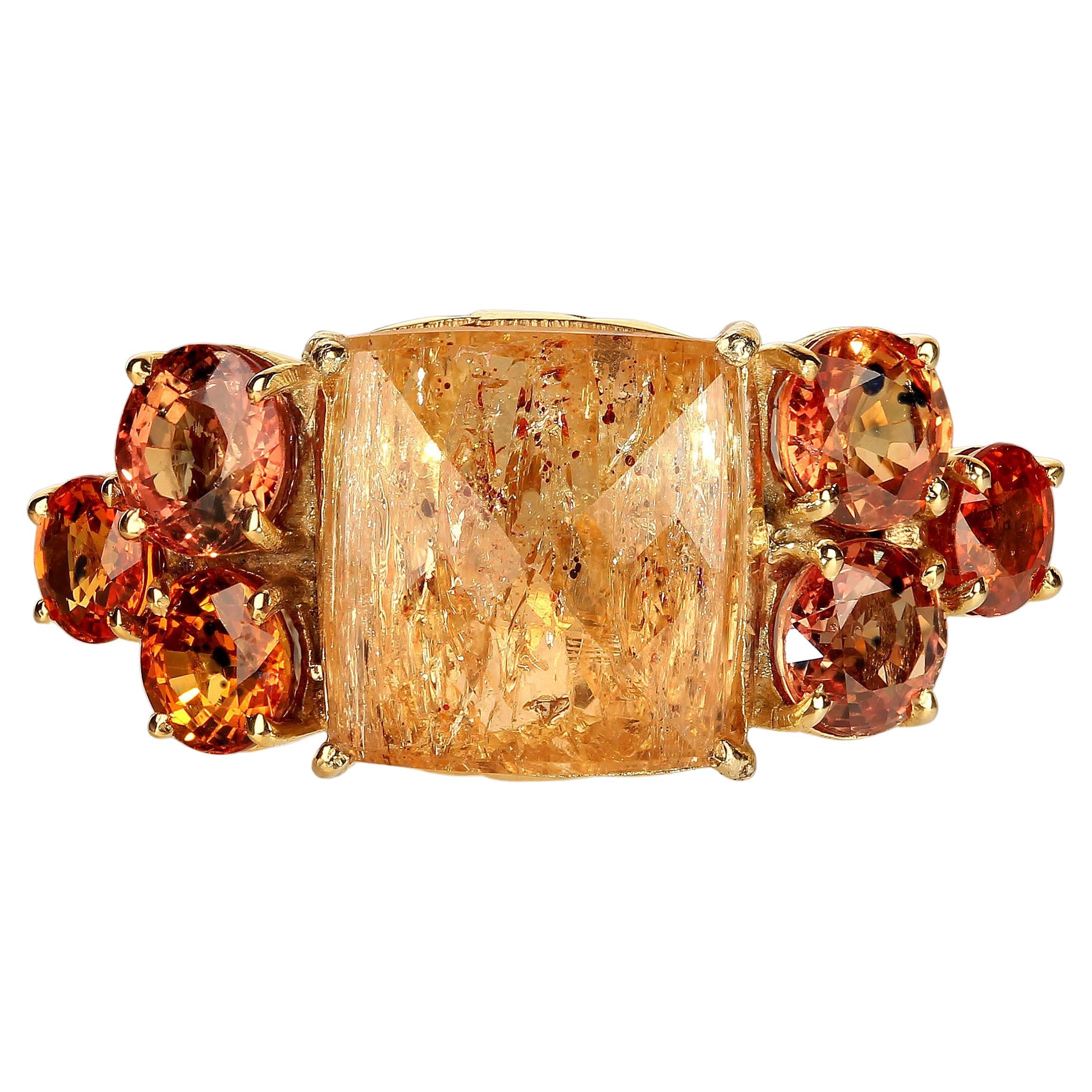 Magnificent dinner ring of golden Imperial Topaz and Orange Songea Sapphires. This one-of-a-kind bold ring is a half and inch knuckle to knuckle and more than an inch wide across your fingers.  The gemstones sparkle and dance in the light as your