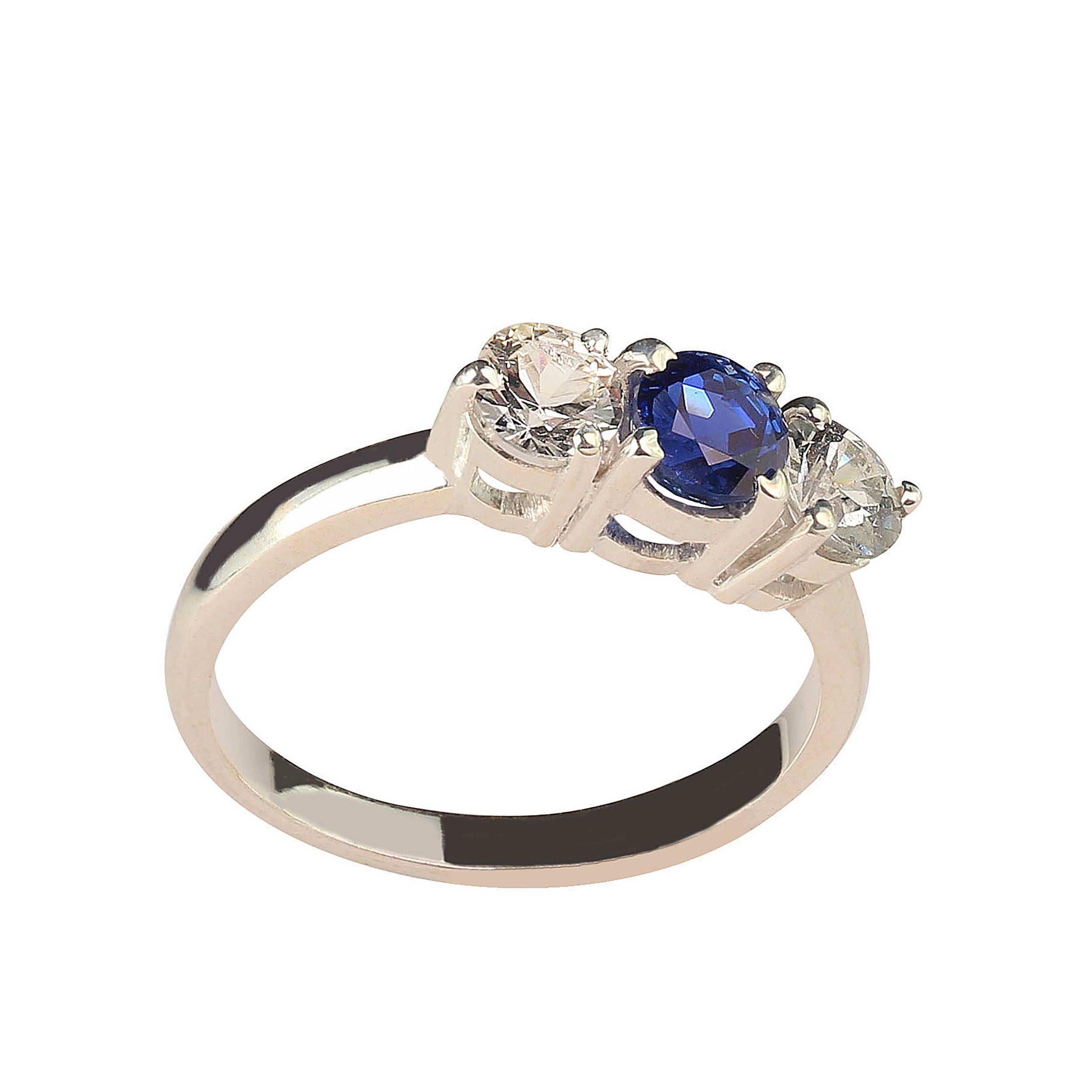 Classic three-stone ring. Delightful ring of sparkling sapphires. The center bright blue sapphire is accented with a white sapphire on each side.  The blue sapphire weighs 0.77 carats and the two white sapphires total 0.82   carats. Sizable 7.5. 