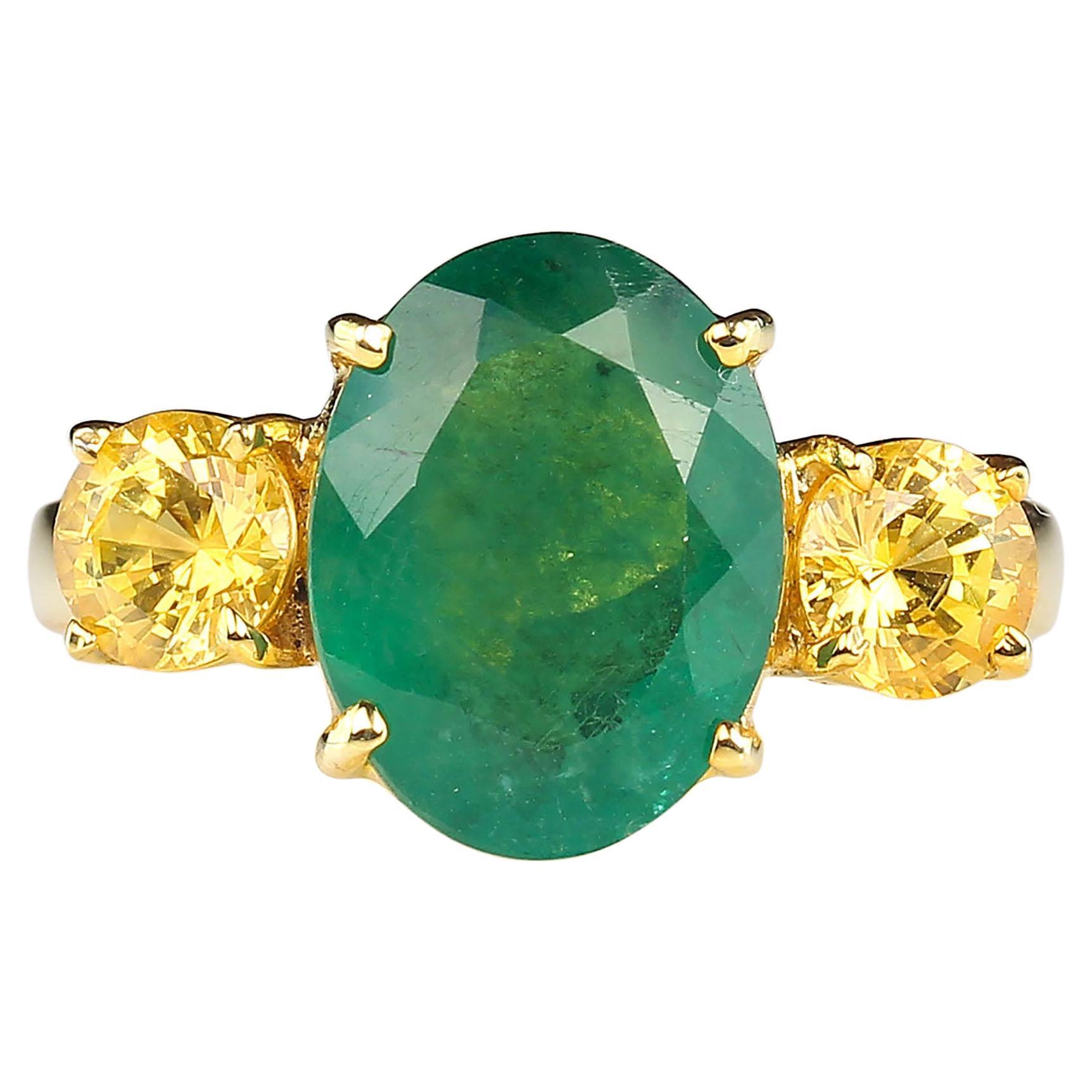 Striking dinner ring of large 3.11 carat oval Emerald accented with sparkling round golden Citrines, 1.3 carats total weigh. This setting is gold rhodium over Sterling Silver and a nice weight and width to balance the size of the gemstones.
