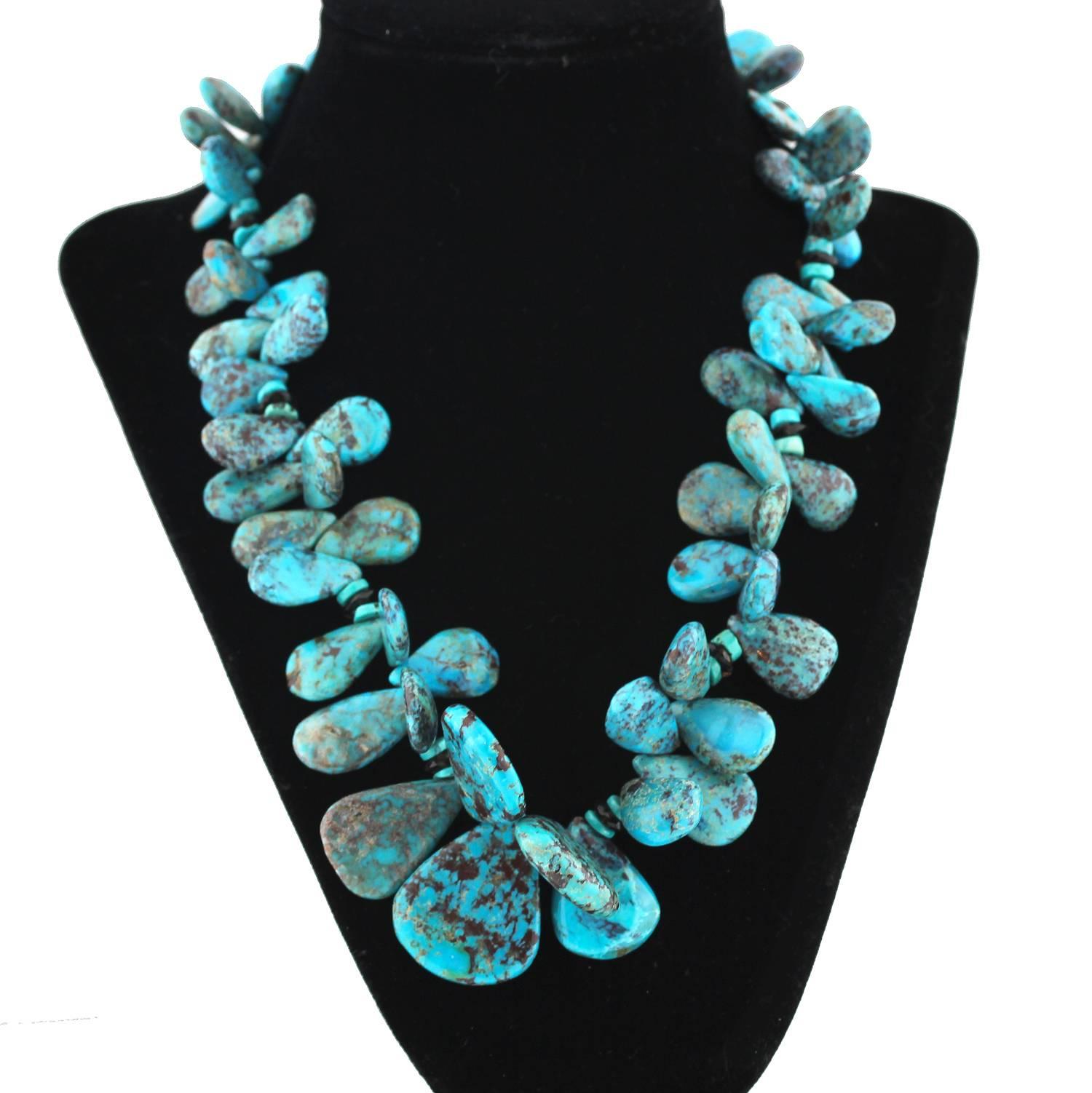 Flamboyant flowery unique natural blue and chocolate Arizona Turquoise (now very rare) accented with Smoky Quartz compose this handmade necklace.  Size:  graduated with largest Turquoise approximately 40 mm long;  Length:  19 inches;  Clasp:  Silver