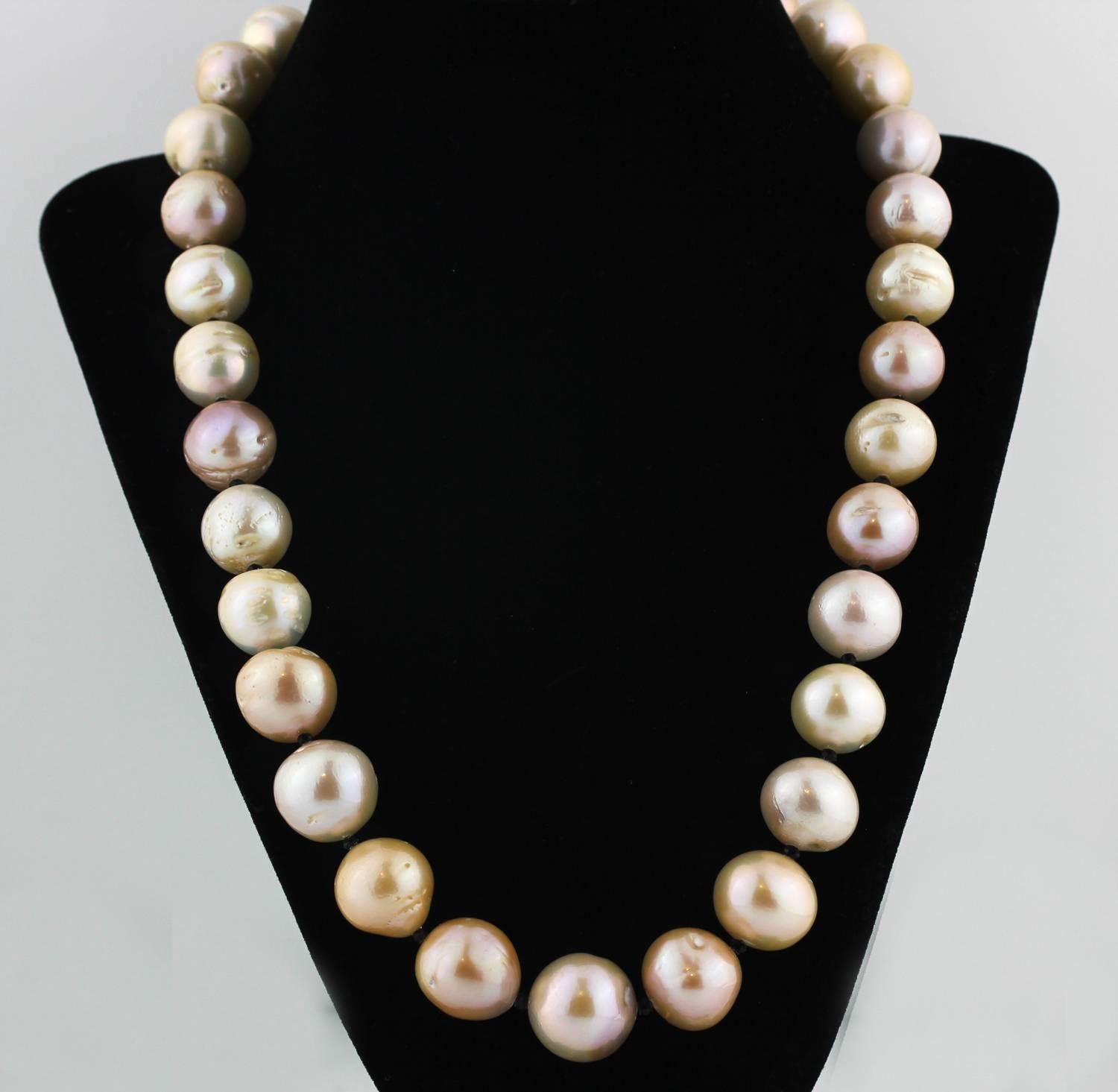 Huge, big round imperfect slightly iridescent goldy champagne tone cultured Tahitian Pearl necklace.  These pearls  reflect differently on different color backgrounds.  Just look at the georgeous play of color!   The necklace has tiny black onyx