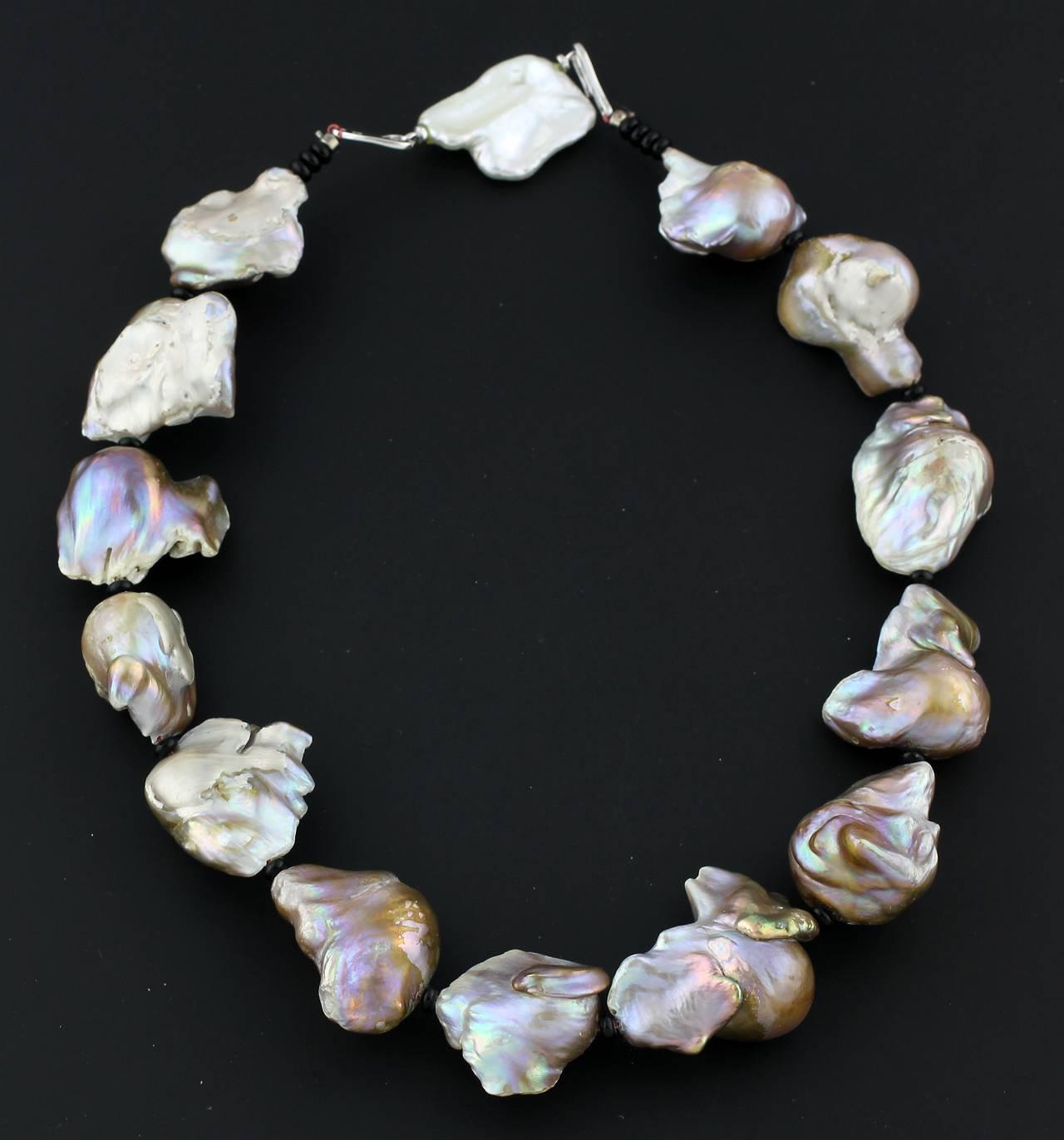 These large almost iridescent cultured South Sea Baroque Pearls have many different tones of pearlescence.  They are all freeform and interestingly shaped.  The necklace length is a pleasing 18.5inches and the largest pearl measures approximately
