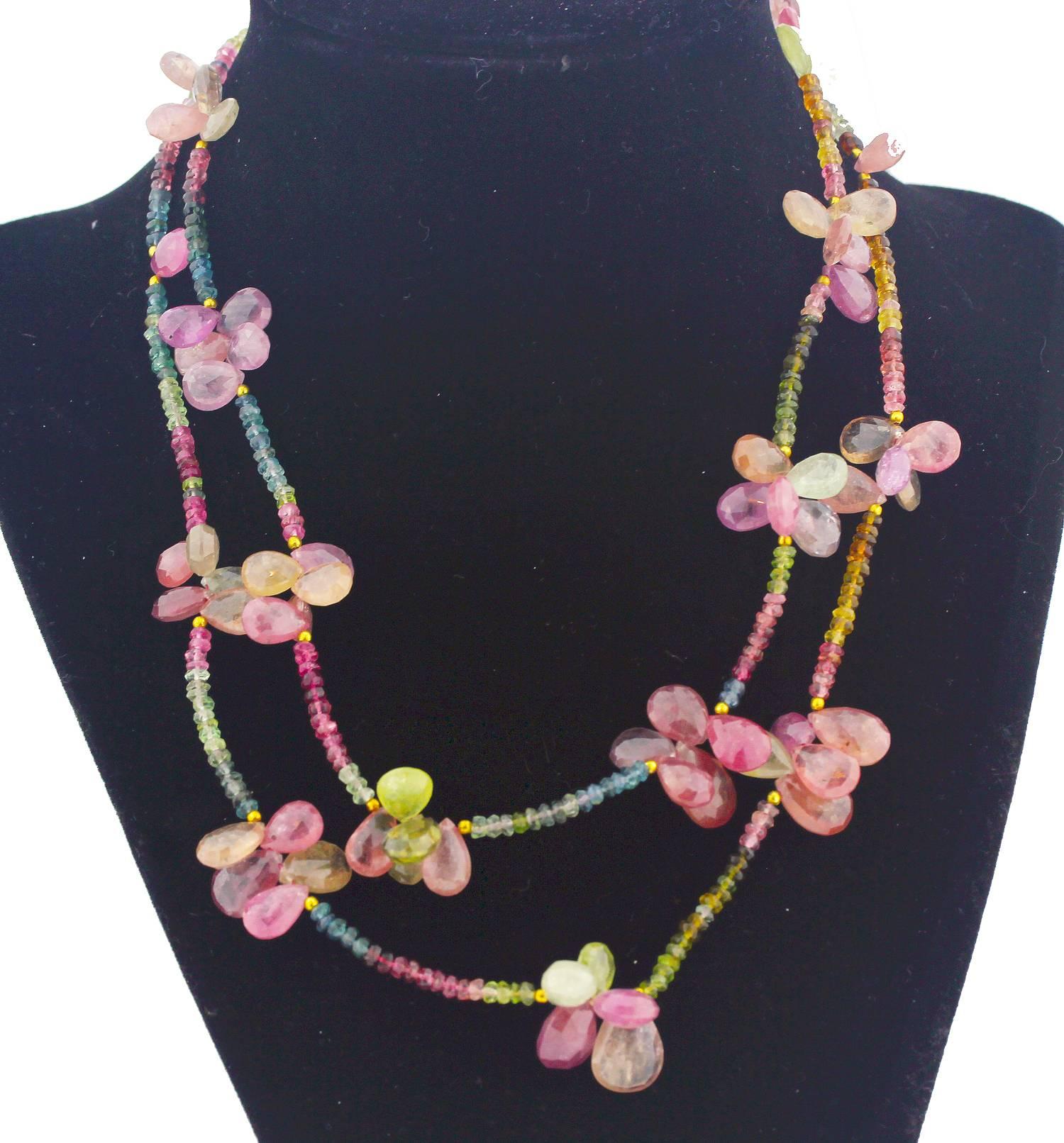 A double strand choker, 16.5 inches in length, of multi-colors of sparkling Sapphires.  Interspersed along each strand are clusters of gem cut red/pink  Sapphire petals  that look like “flowers” or “beautiful butterflies.”  
These Sapphires are