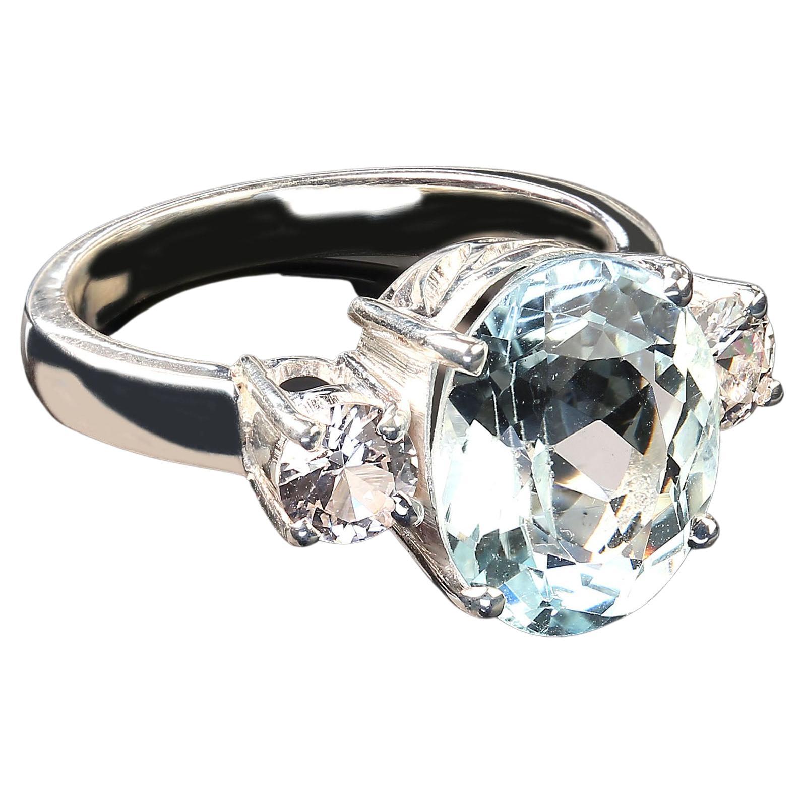 Glittering blue oval Aquamarine ring just waiting to grace your hand.  This gorgeous 5.31 carat beauty comes straight from one of our favorite Brazilian suppliers.  We have accented it with white Sapphires(0.82ct). These gemstones have been set in a