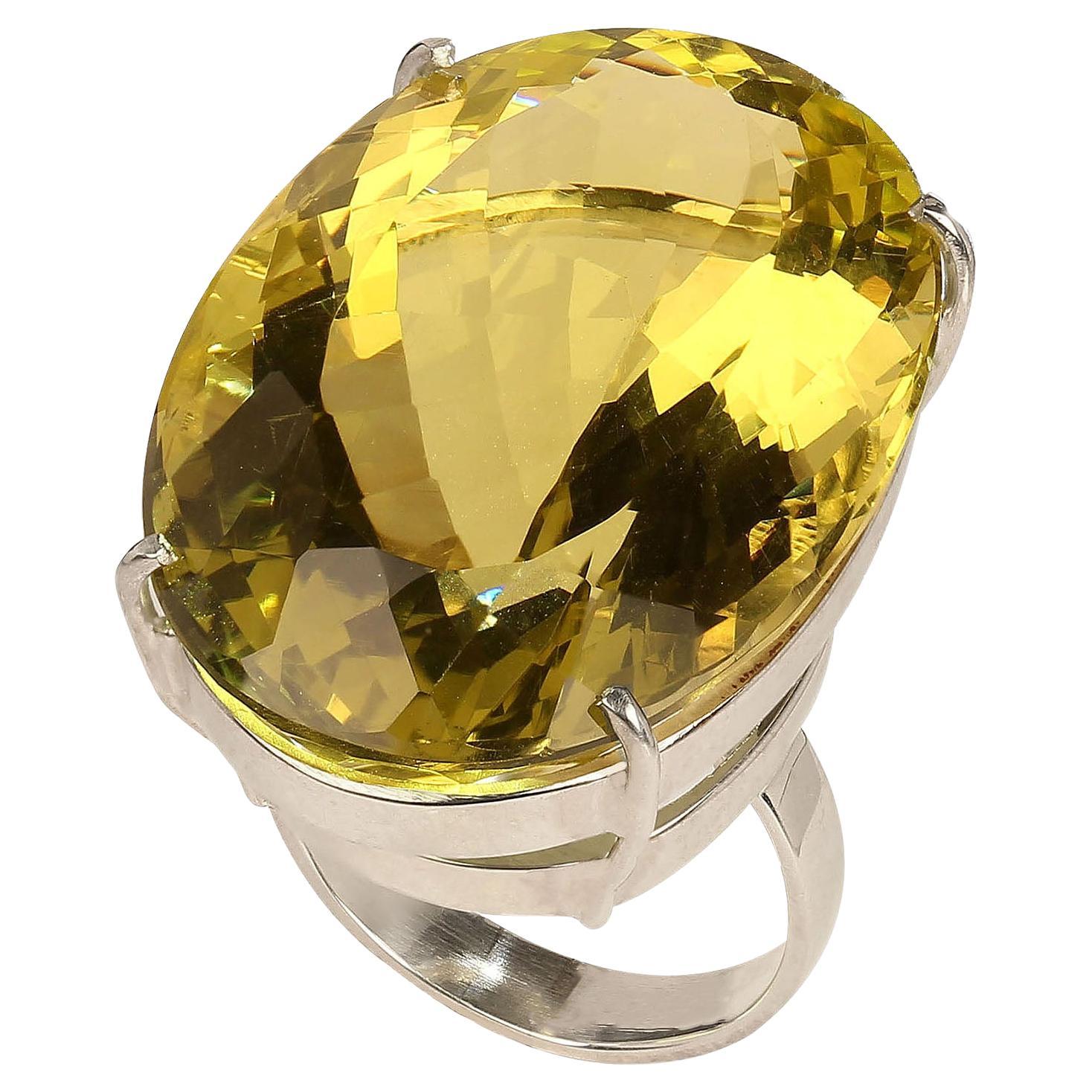 Magnificent 65 carat oval Lemon Quartz in Sterling Silver ring.  The huge ring is 34 X 23 MM making it truly knuckle to knuckle.  The gemcut  is so sparkly it is delight to wear.  This gorgeous Brazilian gem comes from one of our favorite suppliers
