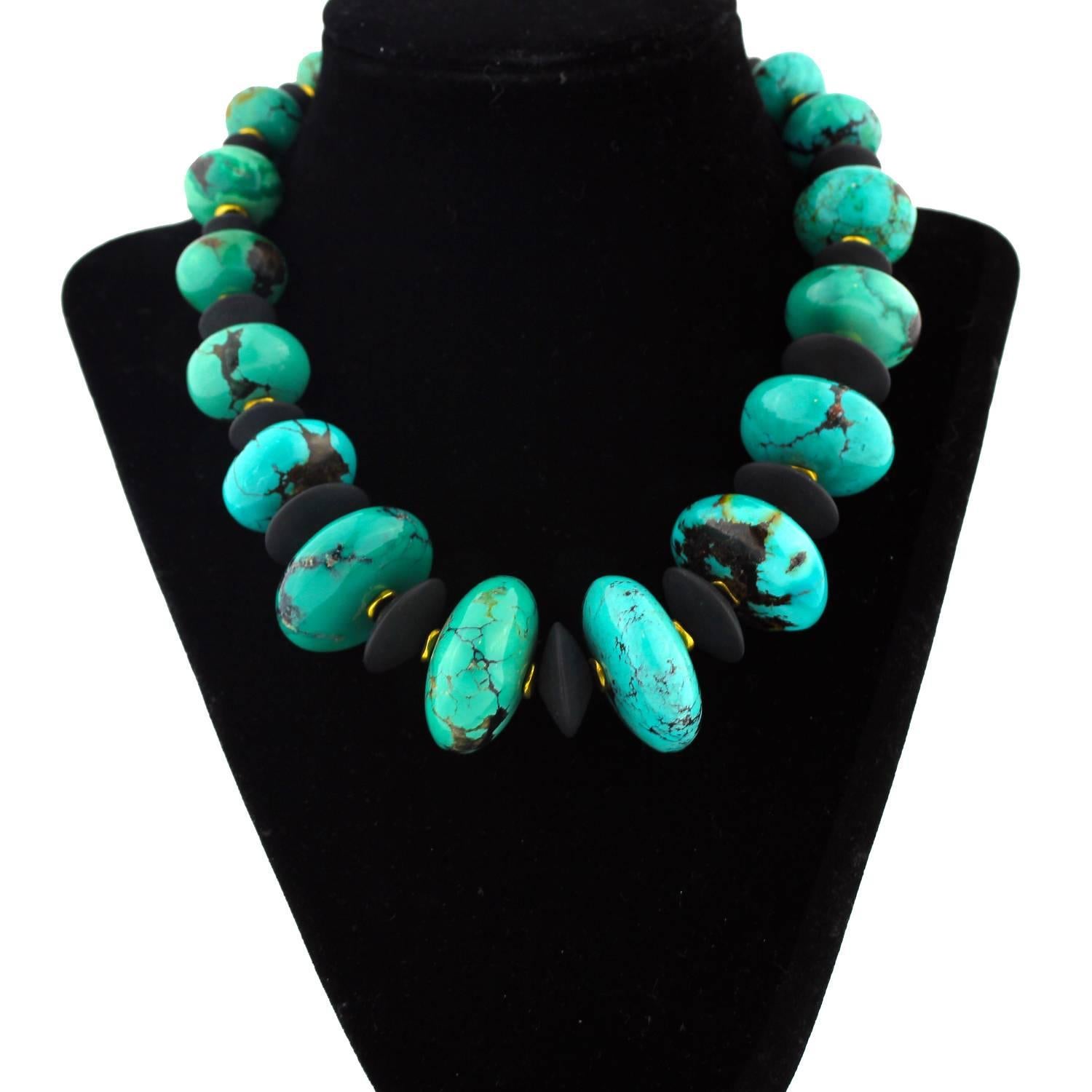 Extraordinary highly polished  17 inch long graduated natural glowing American Turquoise handmade necklace.   The focal point gemstone is 32.7mm.  These luscious Turquoise rondells are enhanced with flat black Onyx and gold tone accents and clasp in