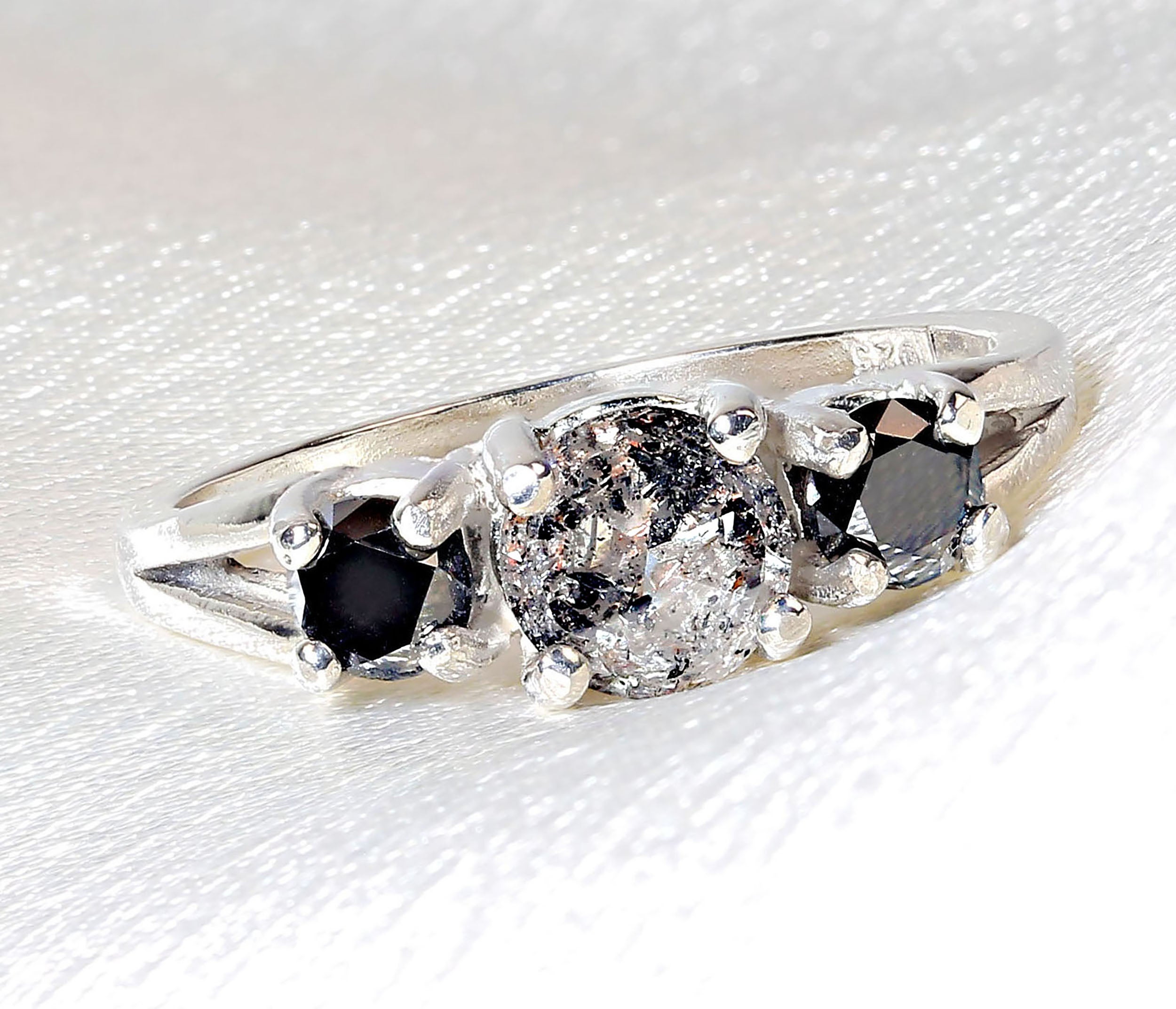 Unique Salt and Pepper Diamond flanked by Black Diamonds Set in Sterling Silver.  This elegant ring features the unusual and unique 'Salt and Pepper' diamond of 0.86 ct. Salt and Pepper diamonds are genuine diamonds with interesting inclusions. 
