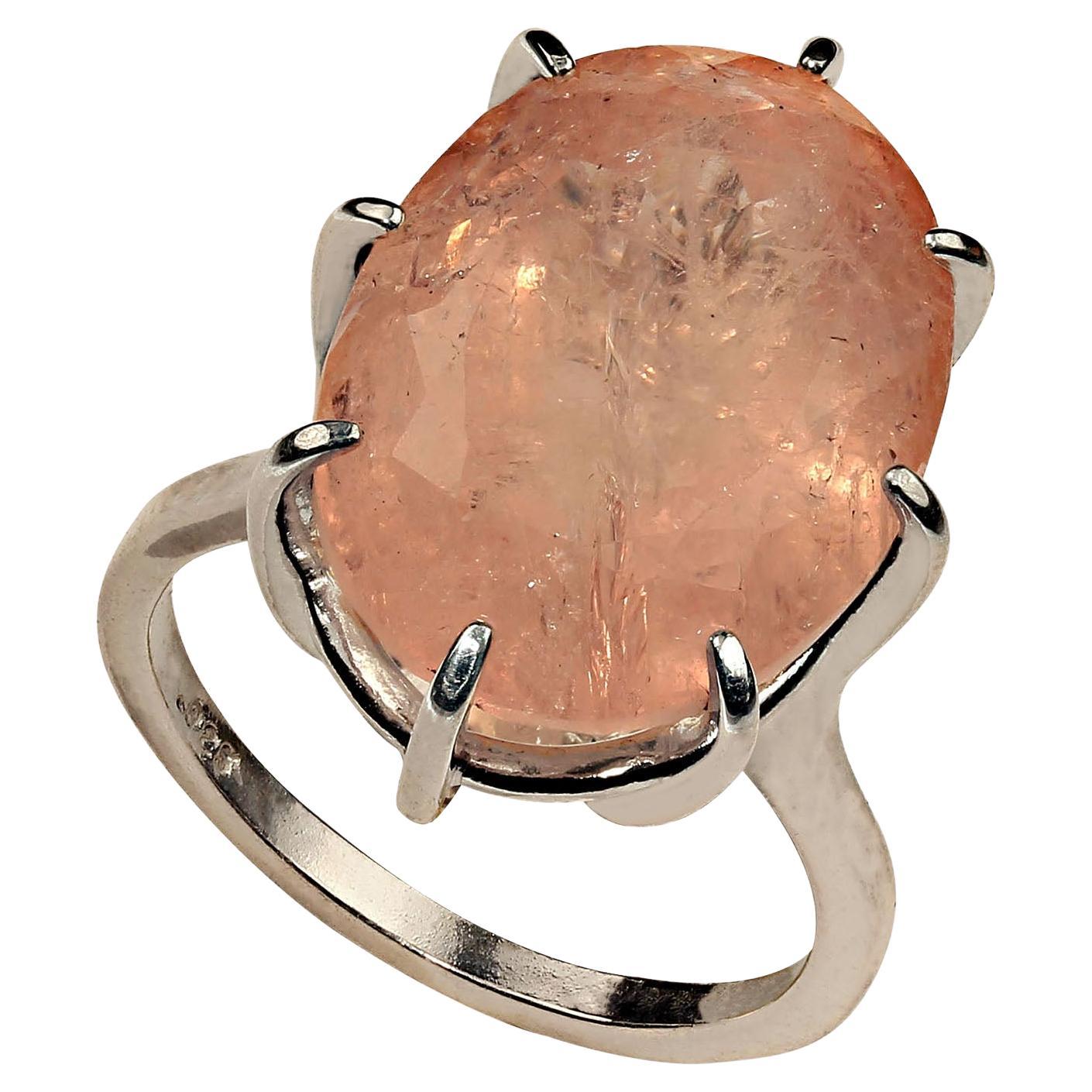 Lovely Pink with a touch of Peach Moranite in Sterling Silver basket setting with 8 prongs.  This 18 X 13 MM gemstone is a rich, medium peachy tone  with all the inclusions typical of beryl. Sizable 7. Take to your local jeweler for sizing.  No