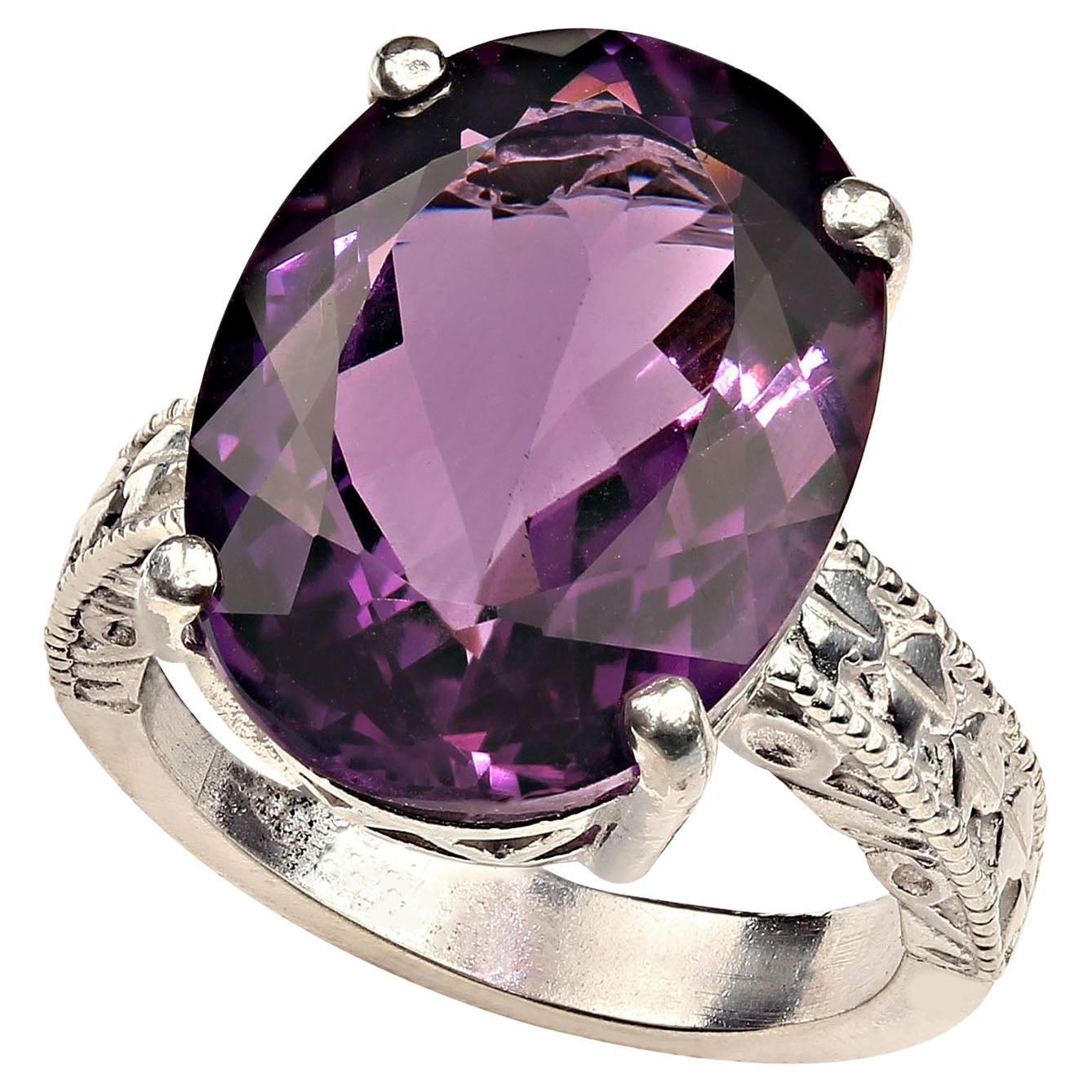 Dazzling oval Amethyst, 12.8 carats, set in 4 prong engraved Sterling Silver ring in perfect for all occaisions.  This brilliant gemstone comes from our favorite supplier up in the mountains outside of Rio de Janeiro.  It's a fabulous medium deep