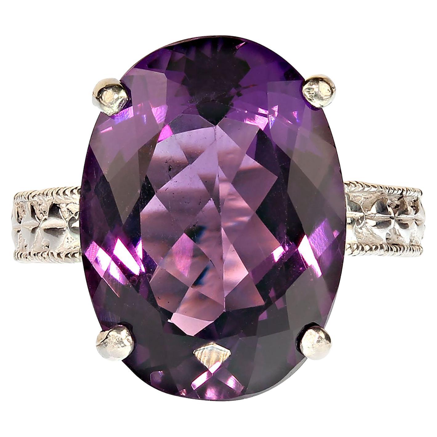 Dazzling oval Amethyst, 12.8 carats, set in 4 prong engraved Sterling Silver ring in perfect for all occaisions.  This brilliant gemstone comes from our favorite supplier up in the mountains outside of Rio de Janeiro.  It's a fabulous medium deep