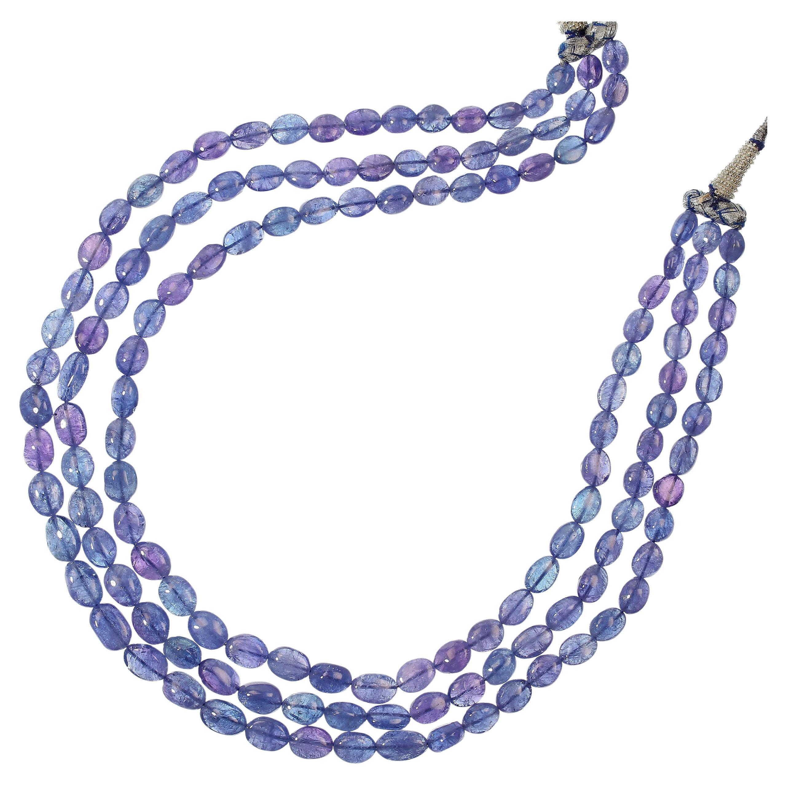 Beautiful three strand necklace of smooth Tanzanites.  These gently graduating tanzanites range approximately from 8 x 6 MM to 12 x 8 MM.  The gemstones are 18 inches and the silver and blue rope expands another 12 inche to slip the necklace over