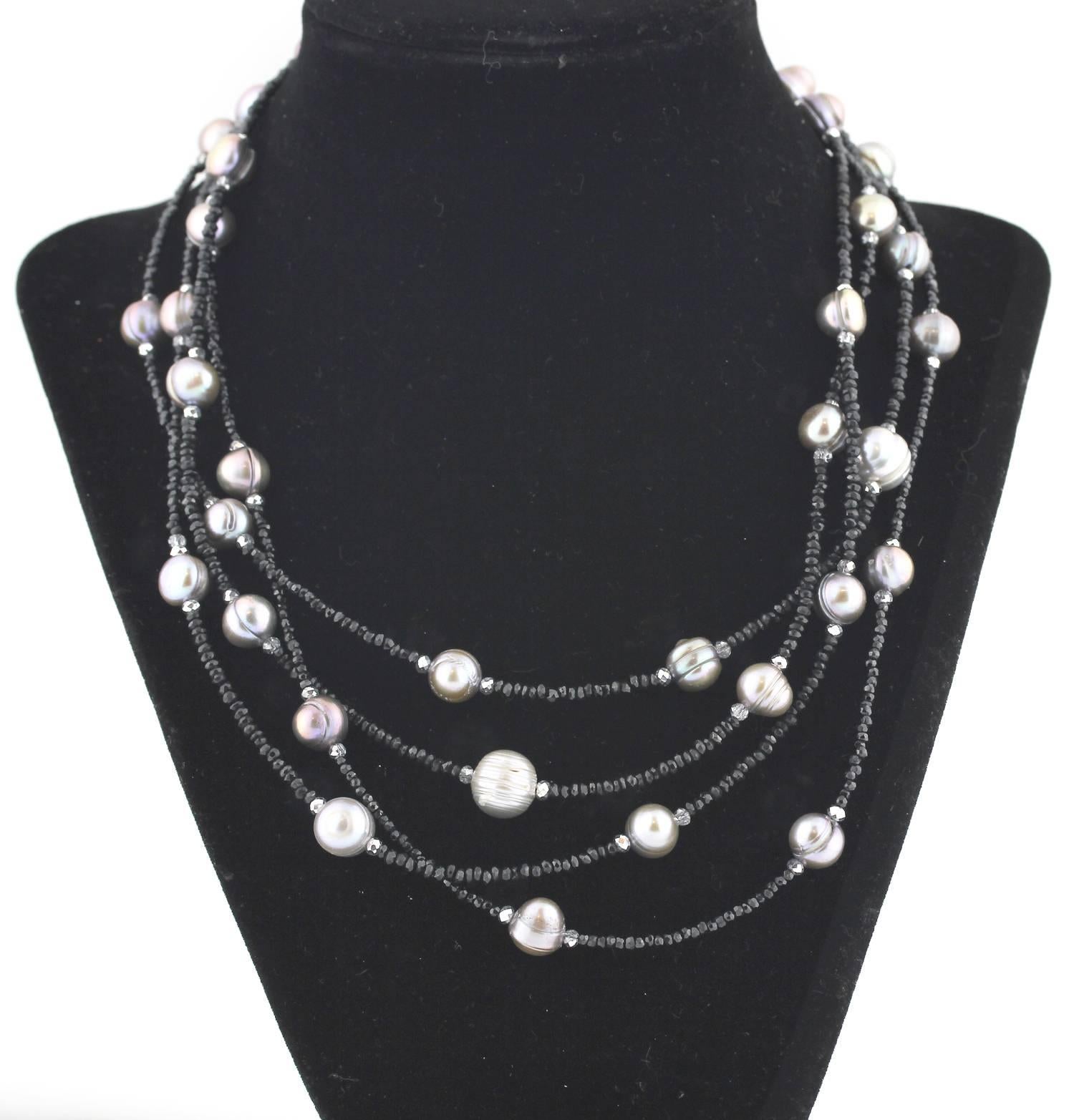 Delicate looking 4 strand sparkling unique Black Spinel Necklace enhanced with slightly graduated silvery rondel cultured Pearls and silvery sparkly accents complete this handmade necklace.  Size:  largest Pearl 11 mm;  Length:  17.5 inches.  More