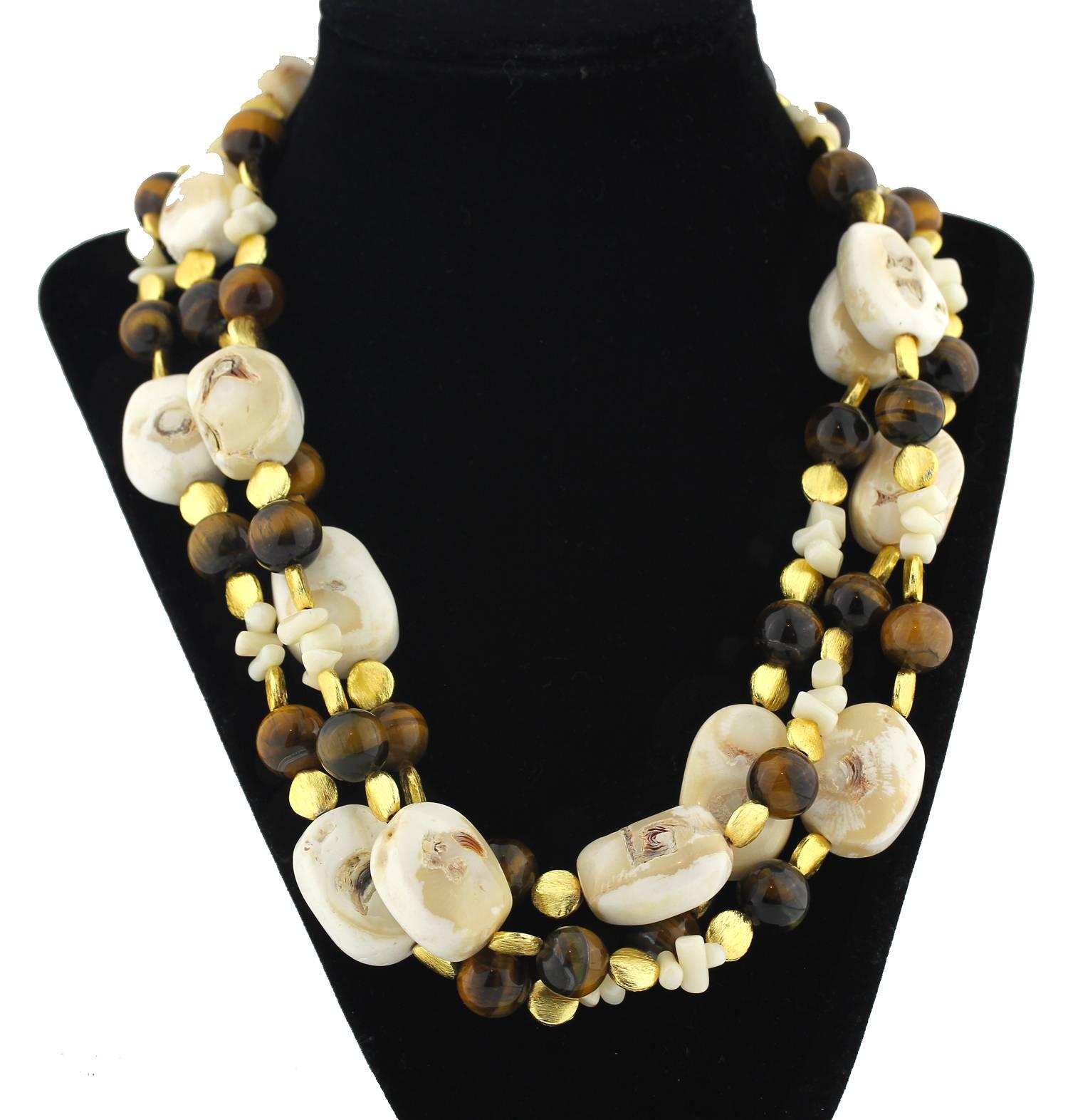 Gemjunky Unique Triple strand Necklace of natural creamy white Coral enhanced with natural brilliant Tiger Eye and gold tone accents handmade necklace. Size:  largest Coral 28 mm;  Length 20 inches
Clasp:  gold tone.  