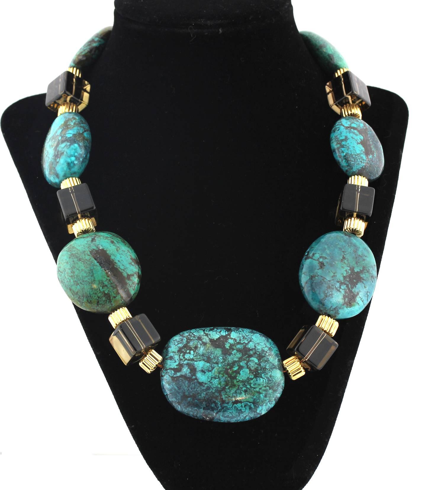 Necklace of Intense unique blueish green Turquoise enhanced with Smoky Quartz cubes and gold tone accents handmade necklace.
Size:  Turquoise varies up to 2 inches
Length:  20 inches
Clasp:  gold tone

