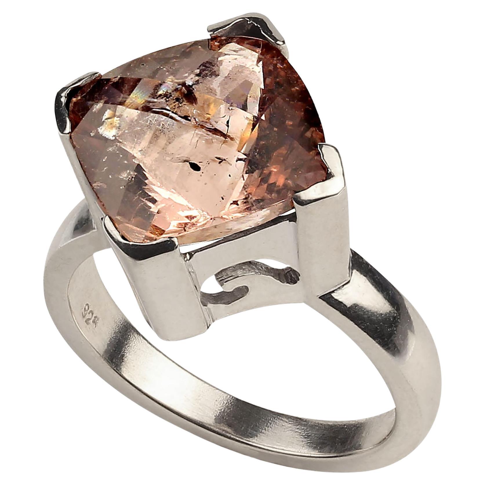 Genuine 7.31ct mouthwatering Morganite set in a lovely detailed Sterling Silver ring.  The antique cushion cut morganite is set at 90 degrees so the corners face your knuckles.  This gemstones features a checkerboard table and is a lovely peachy