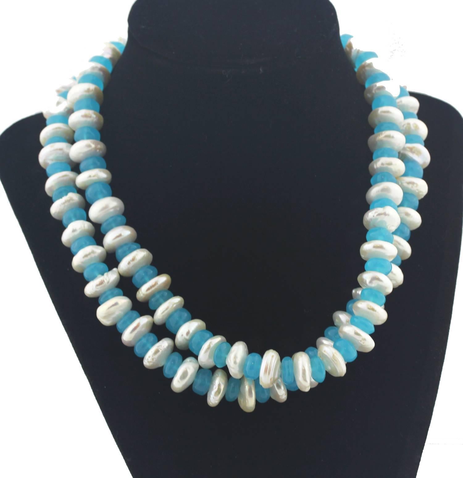 A double strand of highly polished unique glowing translucent Blue Chalcedony rondels enhanced with rondels of natural imperfect Ocean Pearls on this handmade necklace.  Size:  Pearls vary slightly but are approximately 14 mm;  Length:  17.25