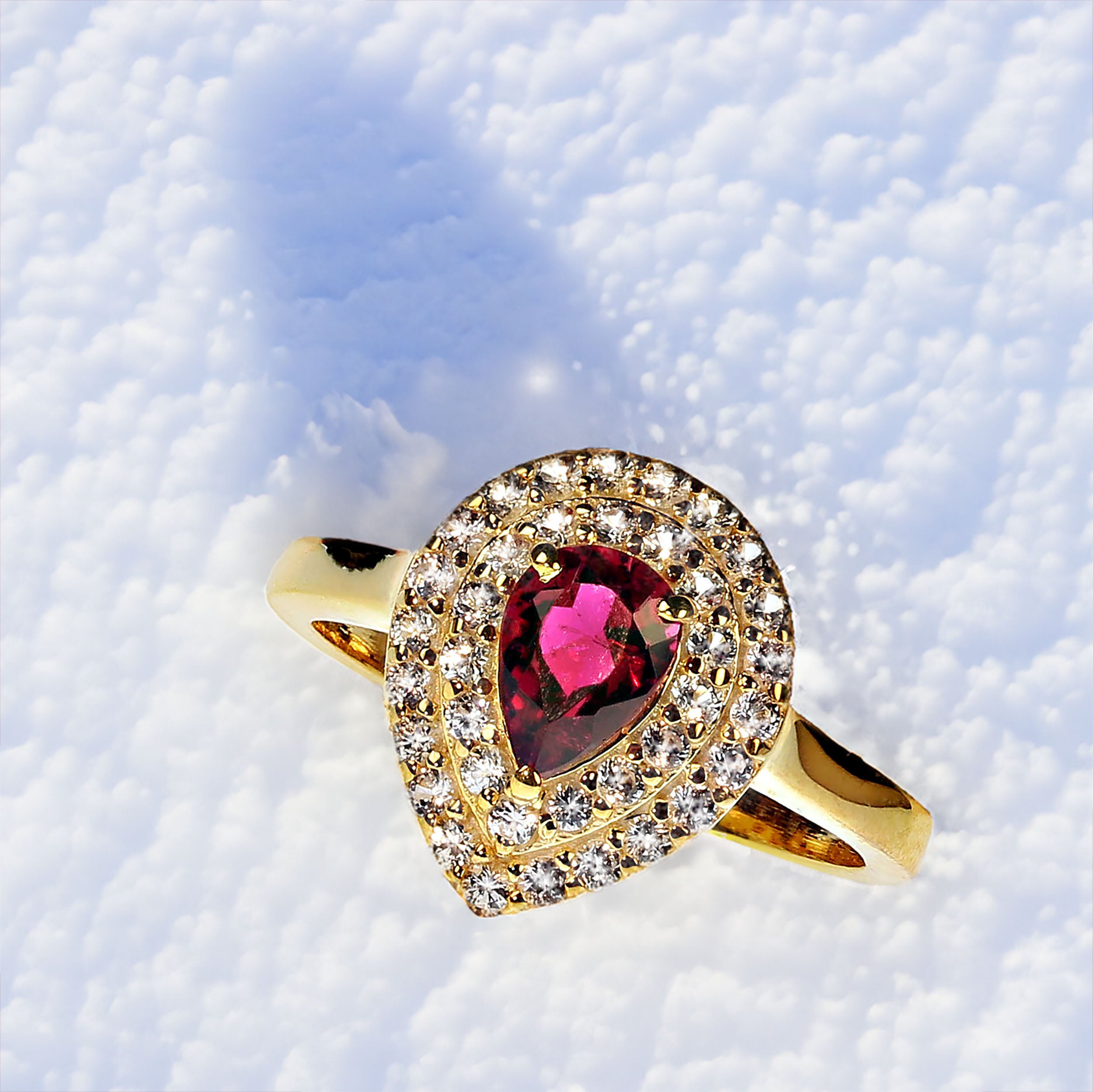 Stunning redish pink rubelite with two surrounds of sparkling white sapphires all set in gold rhodium over sterling silver.  This goreous unique ring will be your go to dinner ring.  The 0.89ct rubelite comes from the Ouro Preto area of Minas