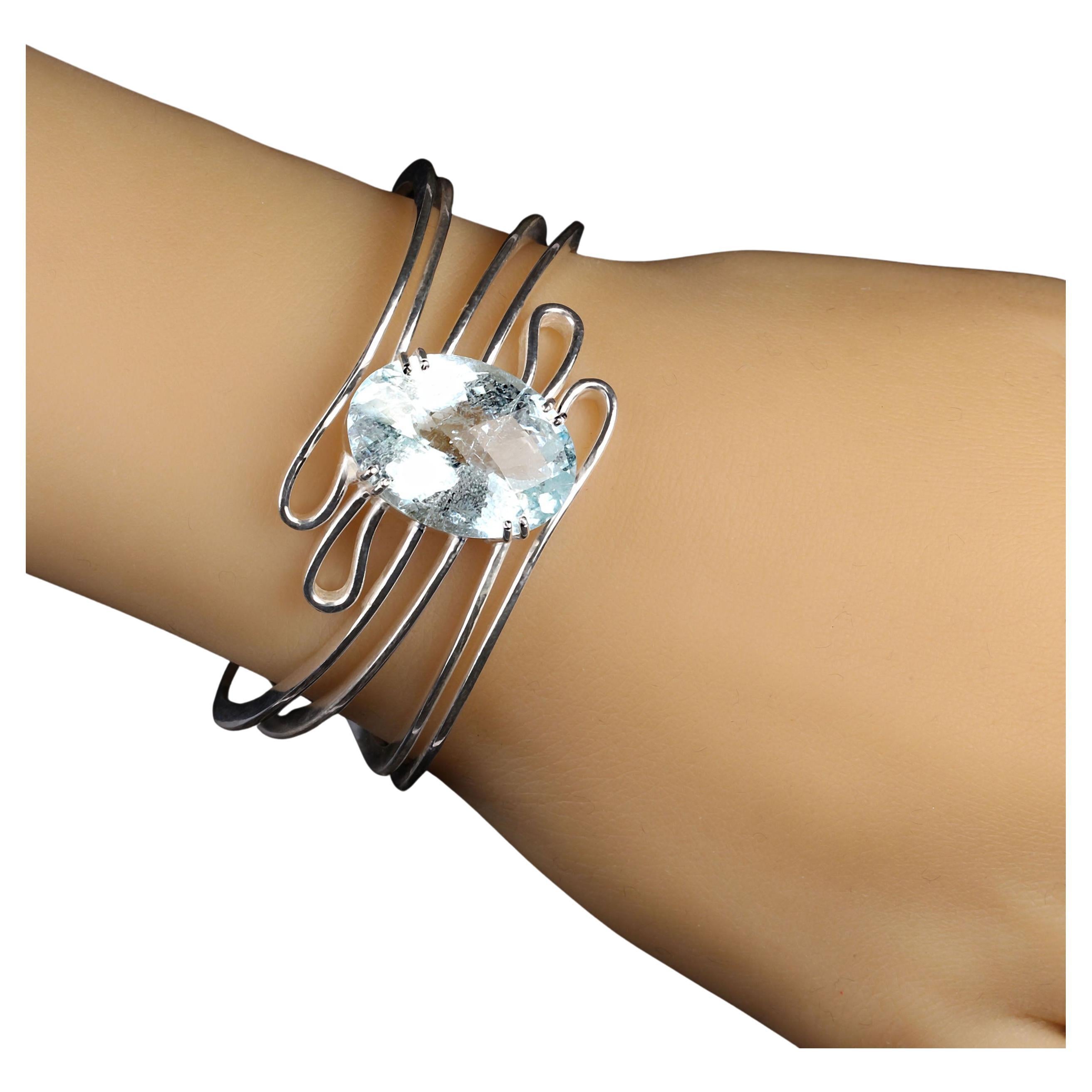 Magnificent 25 carat oval Aquamarine with checkerboard table sits in the middle of swirles of sterling silver.  This cuff bracelet is enchanting. You will love wearing it.  MB2302