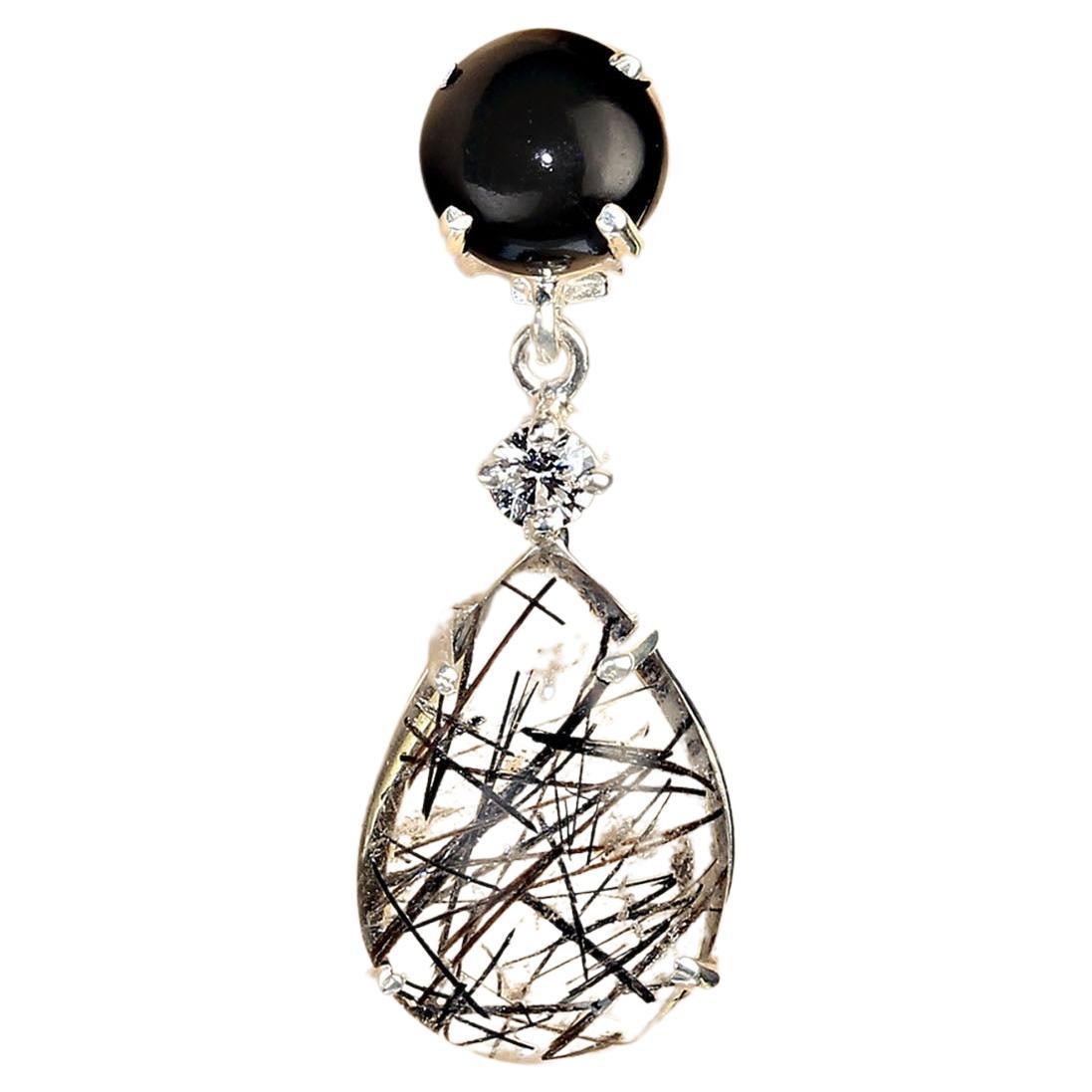 Tourmalinated quartz and black onyx and dangle earrings in sterling silver. These elegant and sophisticated earrings dangle 1.13 inches and feature posts and push backs. The pear shaped cabochon tourmalinated quartz total 9.88ctw. The round cabochon