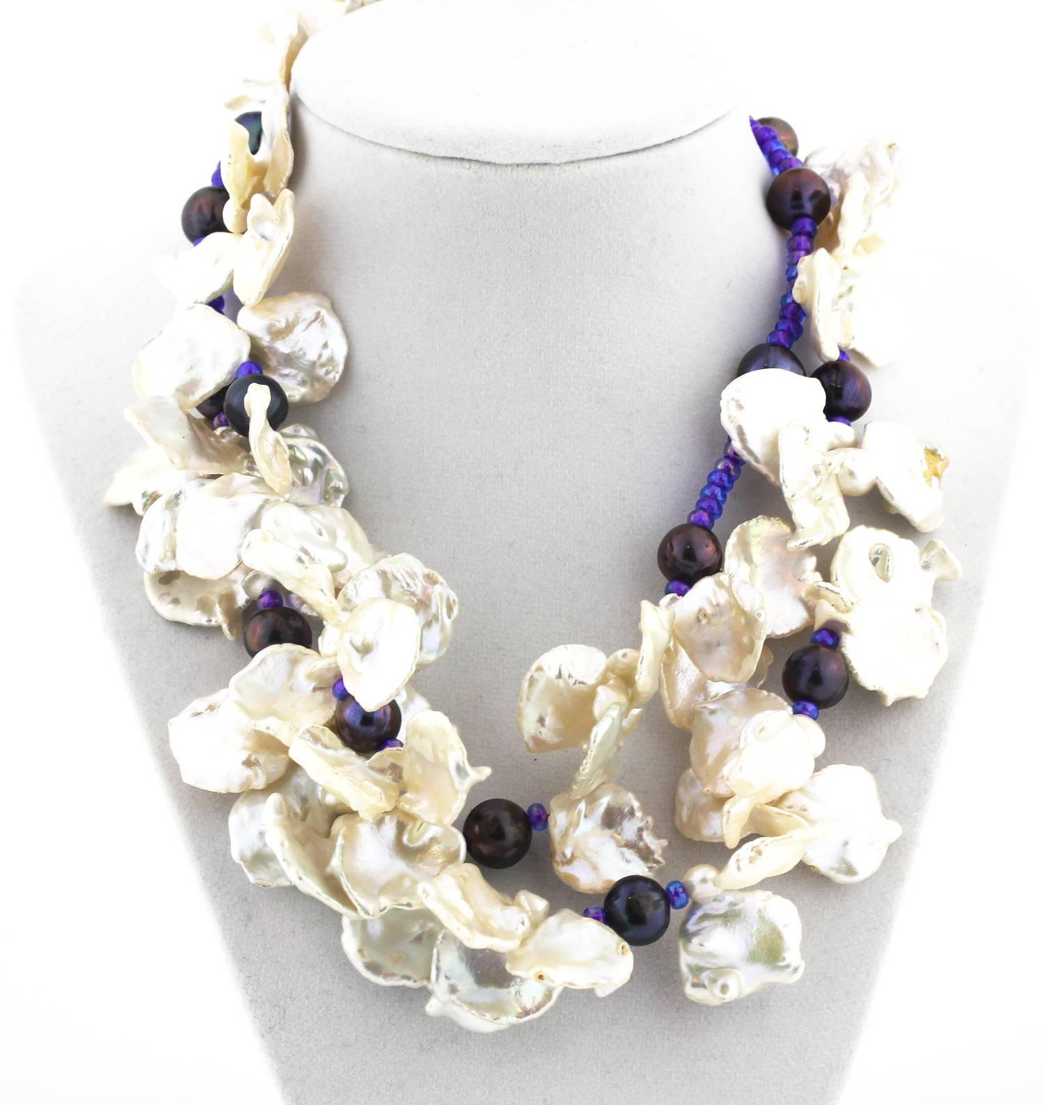 Double strand of Flowery white Keshi  pearls interspersed with purple Fireball pearls and sparkly accents necklace
Size:  white Keshi pearls vary from approximately 1 inch to 1 1/2 inches
Length:  18 inches
Clasp:  silver tone

