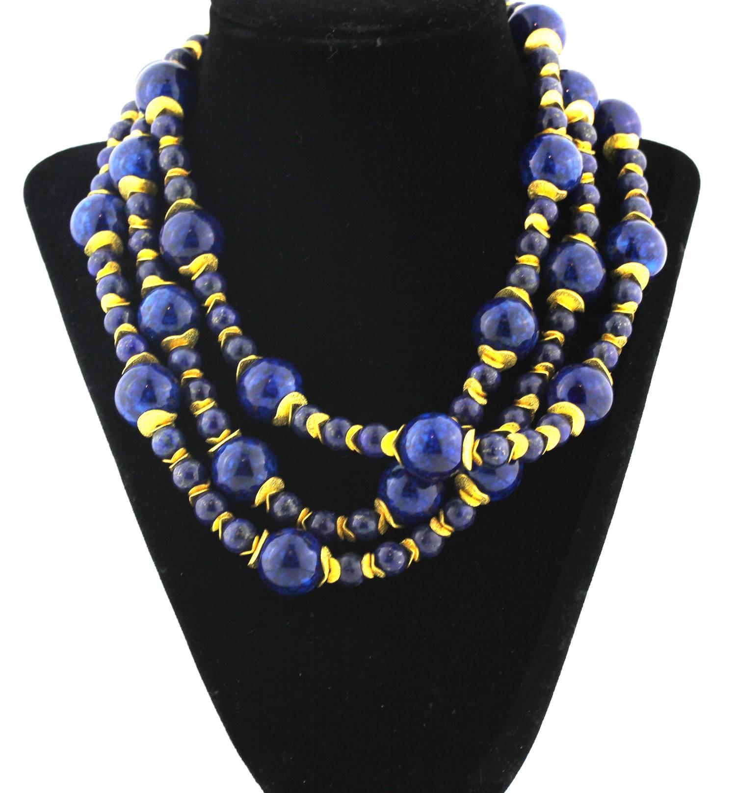 Triple strand of natural Lapis Lazuli from Afghanistan mixed with Blue Coral nicely polished to show off its goldy color flecks with light goldy tone accents necklace
Size:  Large Lapis approximately 16 mm
Length:  17 inches
Clasp:  gold tone