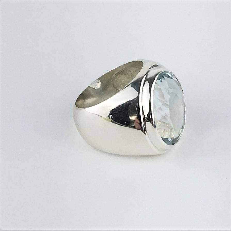Coustom made, sparkling, oval Silver Topaz (18x14mm) Bezel Set in Sterling Silver Ring.  This gemstone was hand selected in Rio de Janeiro and the setting was designed and created by one of our artisans in our studio in the mountains outside of Rio.