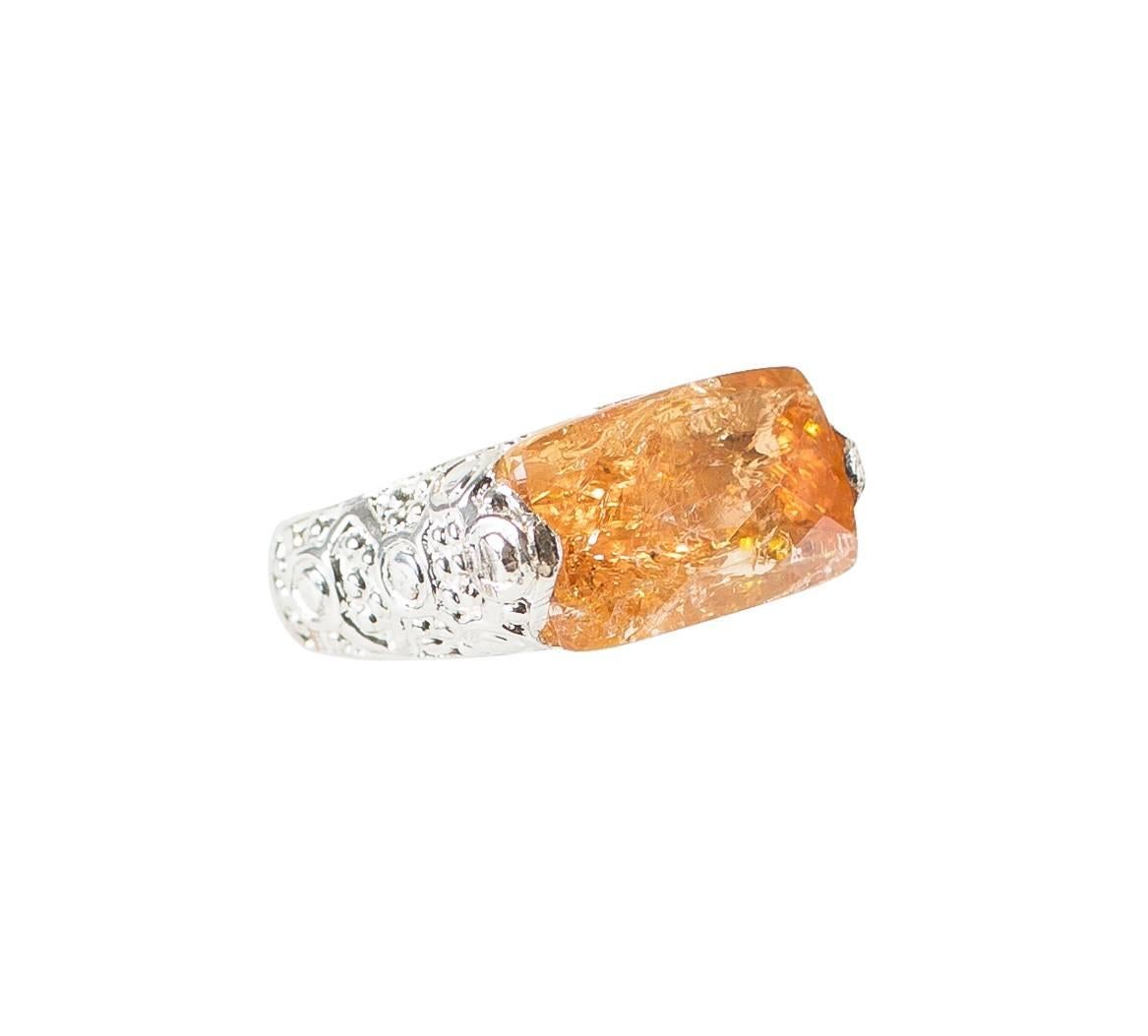Fabulous Orange Brazilian Imperial Topaz set East-West in fancy scrool work patterned Sterling Silver Ring.  This Imperial Topaz came straight from Ouro Preto, Minas Gerais, Brazil.  The gemstone is 15x9mm and has a checkerboard table.  Size 7.
The