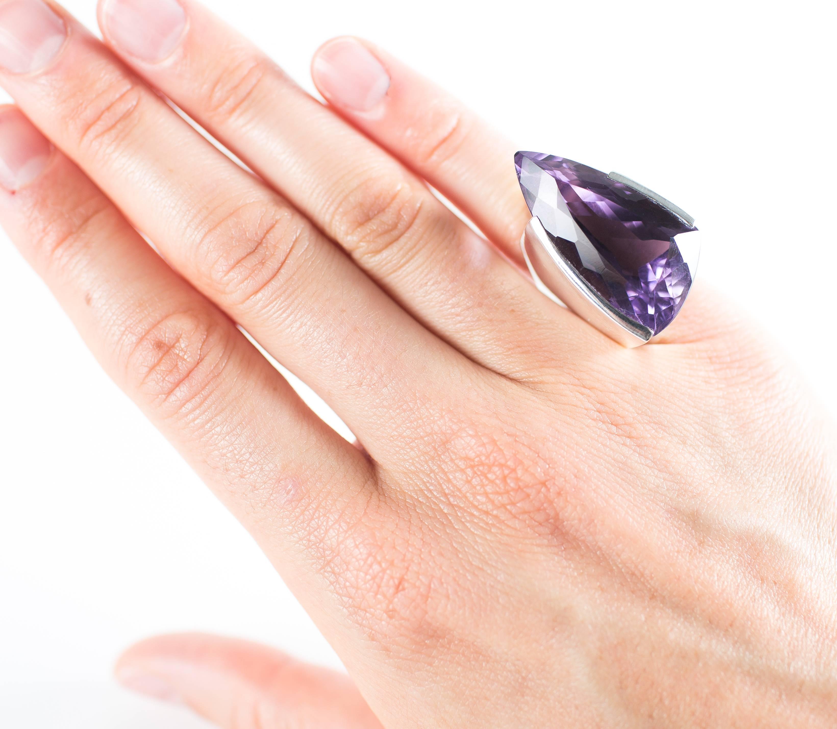 Fabulous Brazilian fancy cut Amethyst set in Sterling Silver by Rio de Janeiro designer Hans Stahr.  This beautiful Amethyst sparkles with flashes of pink and purple.  Han's unique design supports the Amethyst while giving it lots of light.  One of