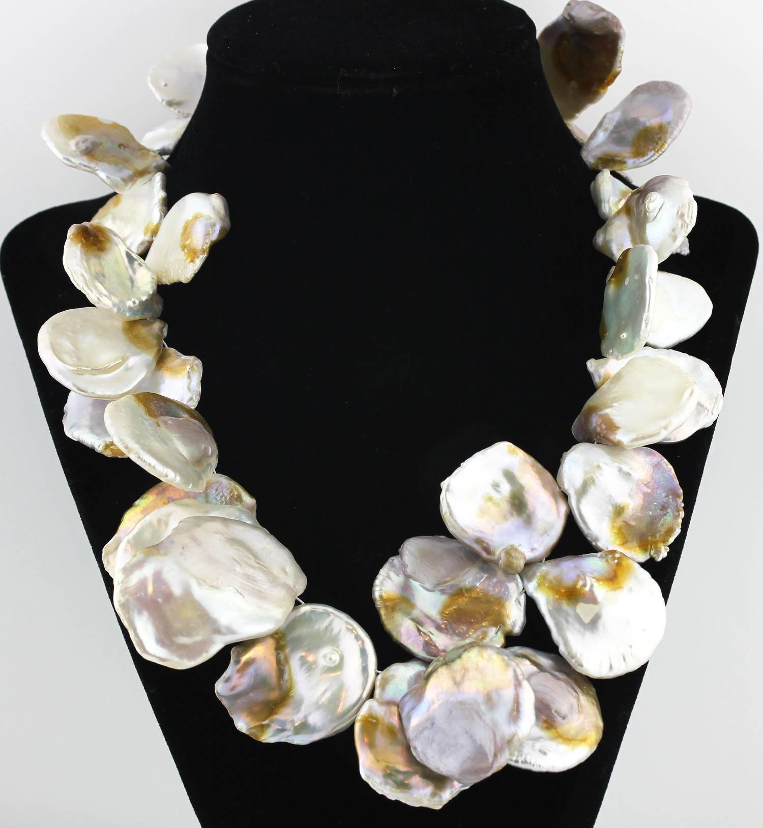 Gemjunky Dramatically big unique pearlessent goldy flecked and silvery playful white Keshi Pearls that you can arrange in different designs by flipping them one direction or another on this handmade pearl necklace.  The nacre is natural.
Size: 