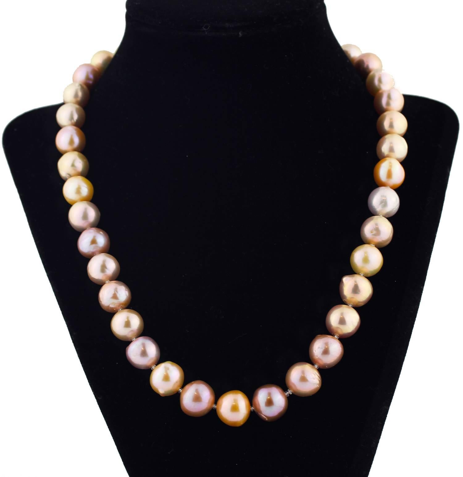 Gemjunky Unique Beautiful soft tones of iridescent pearlescent goldy cream and mauve tones of these glowing natural cultured Pearls on this handmade necklace.  Size:  slightly graduated up to approximately 13 mm;  Length:  19 inches;  Clasp:  silver