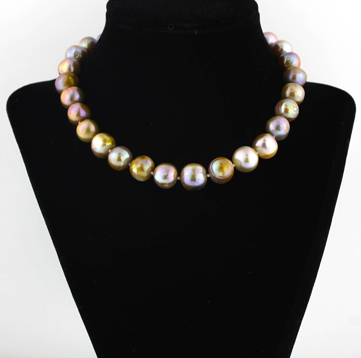 A choker of cultured Fireball iridescent ringed Pearls with a mind of their own  (which reflect different colors on different backgrounds)
Size:  approximately 13 mm
Length:  15 inches
Clasp:  silver tone