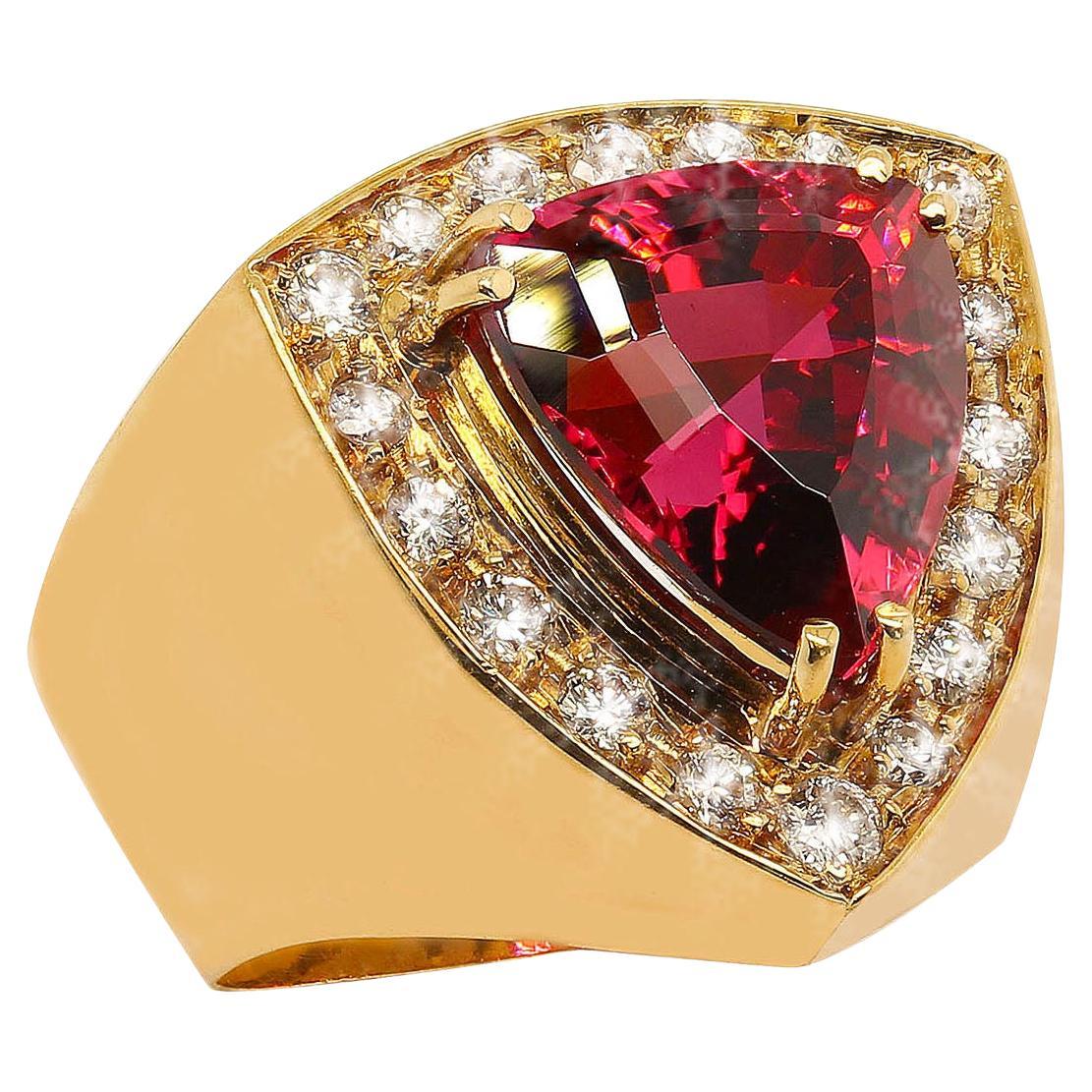 18K Yellow Gold Ring with Sparkling Trillion Rubelite (11x10mm) set above flat surface with 18 pave set diamonds. This surface itself is 18x17mm.   Heavy gold shank rises up from tapered back to create a stunning setting for the diamonds and