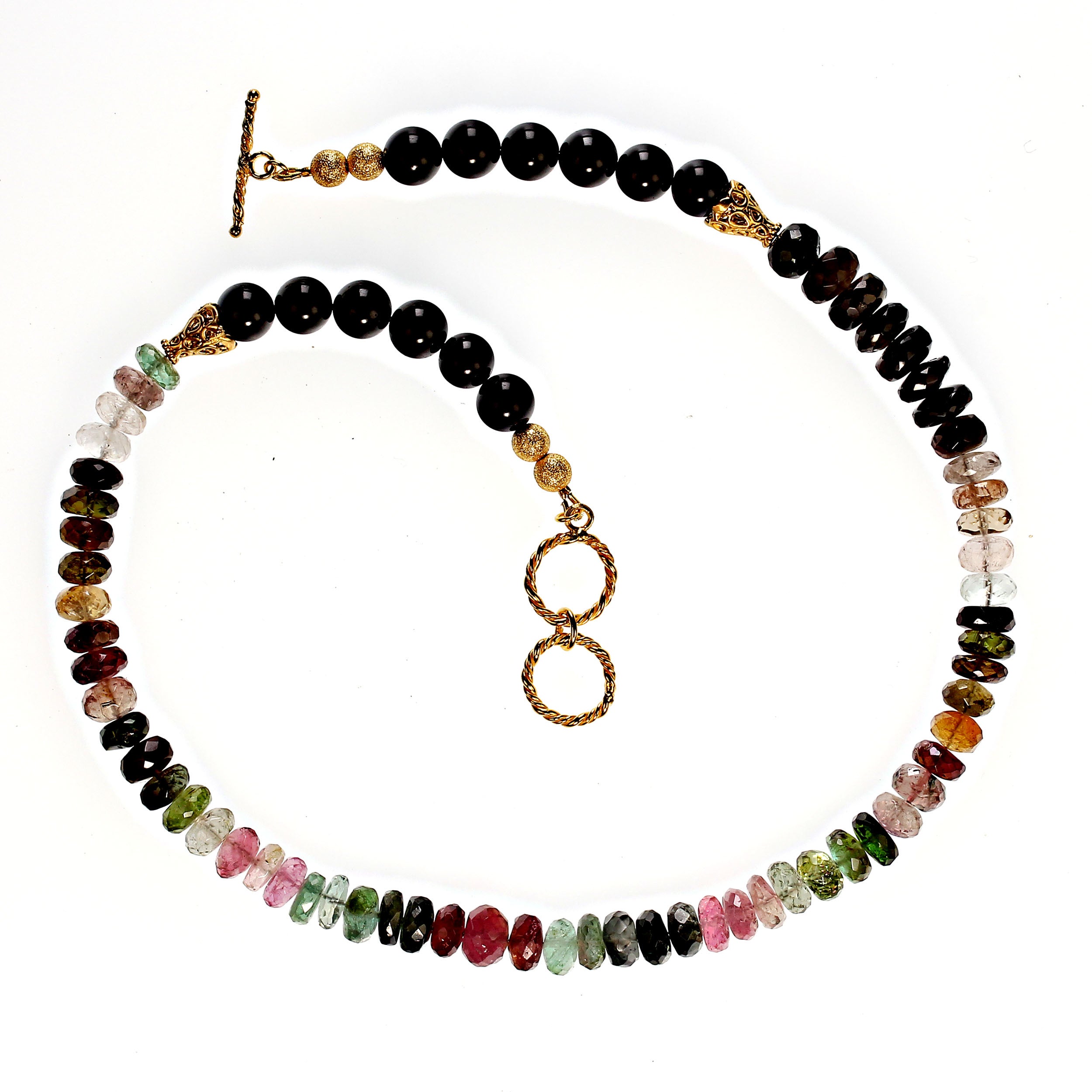18 Inch multi color tourmaline necklace gold plated two ring toggle clasp.  This unique necklace features sparkling 8mm faceted multi color tourmalines and smooth black 8mm tourmalines to extend the back. Perfect for your winter wardrobe.  MN2375