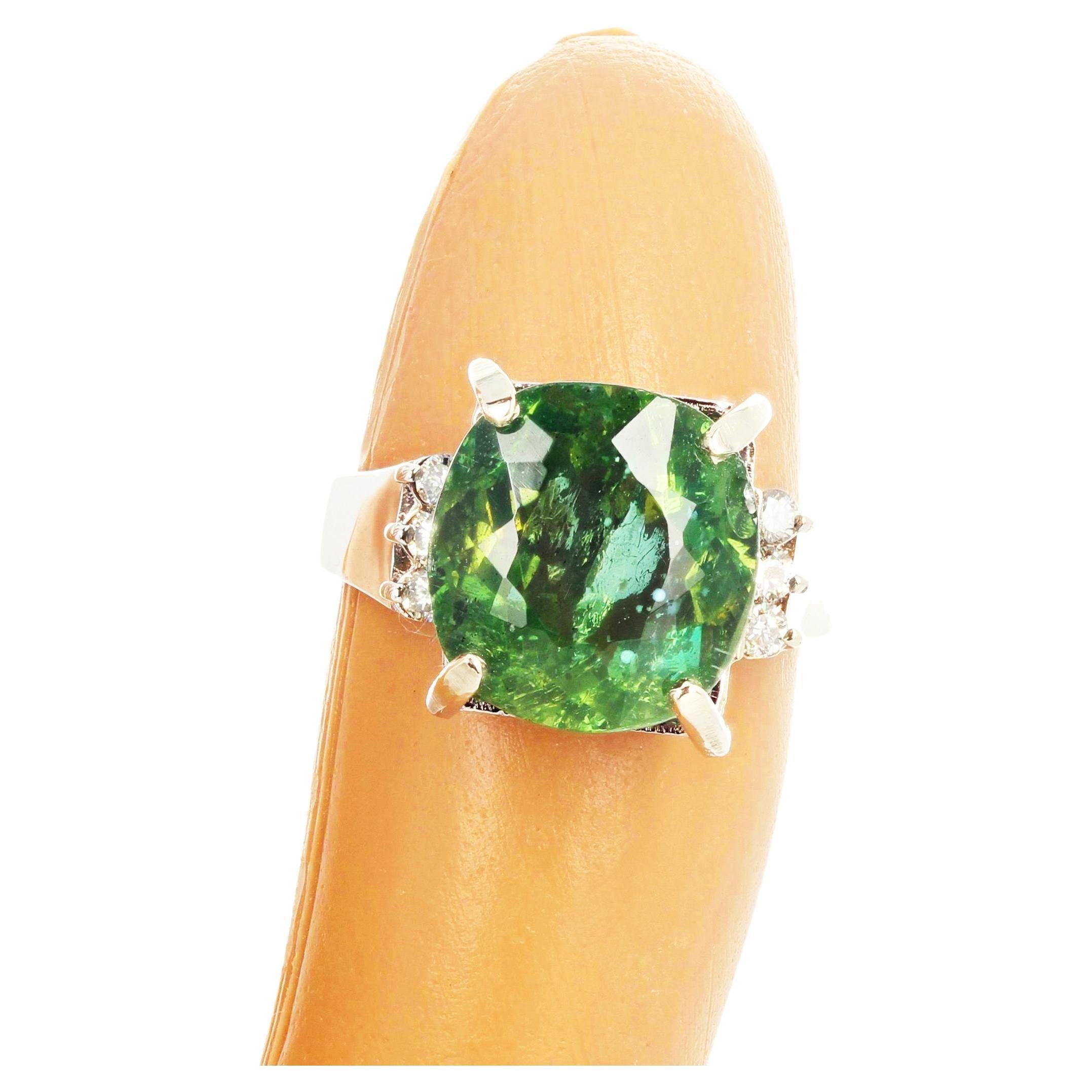 This 8 Carat cushion cut glittering brilliant natural green Madagascar Apatite (12.5mm x 11.9 mm) is enhanced with 6 beautiful sparkling diamonds set in a lovely 14KT white gold ring size 7 (sizable). Spectacular optical effect in the Apatite