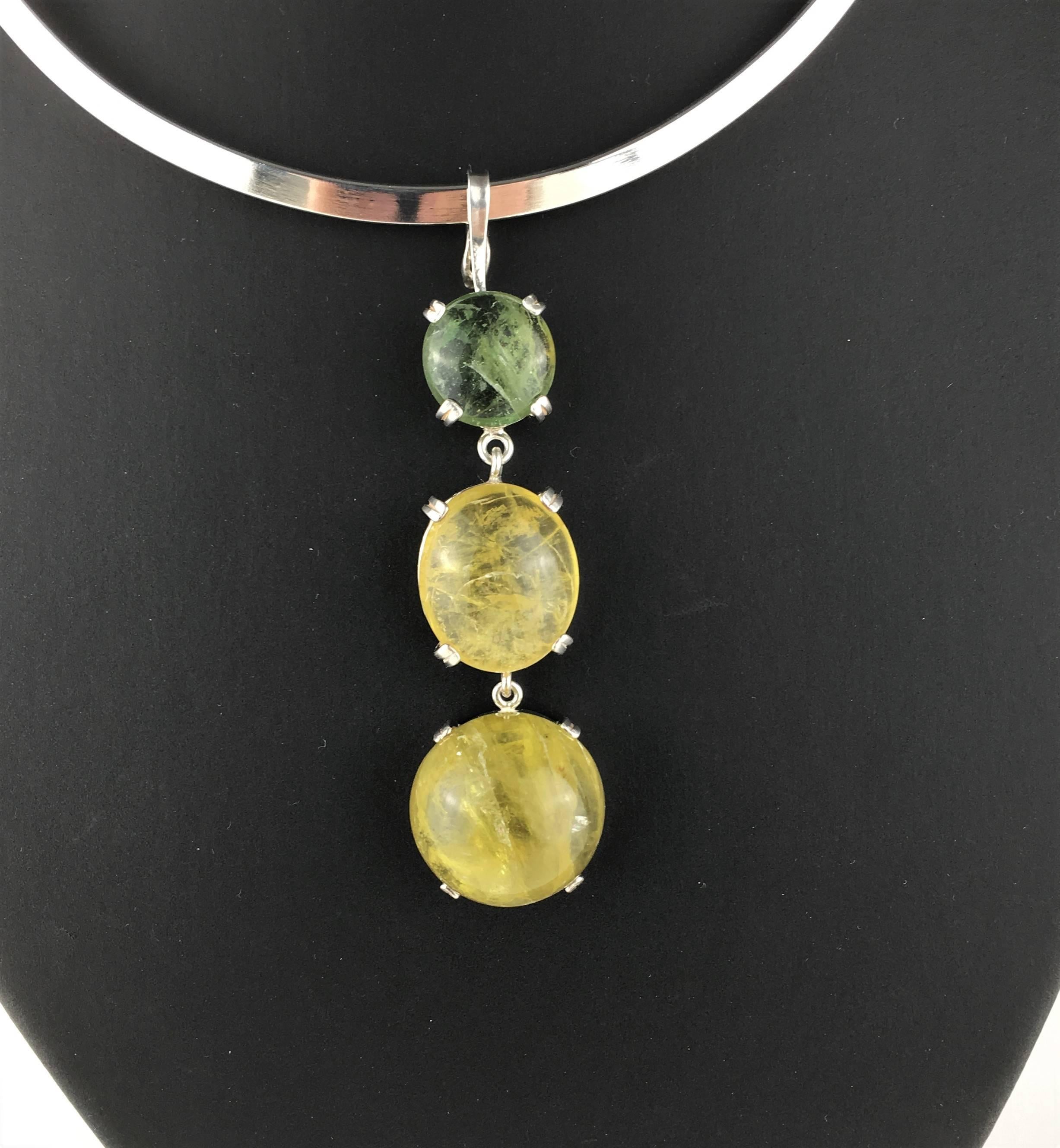 Custom designed and made Sterling Silver Vertical Pendant with Three Glowing Beryl Cabochons. The top is a round green beryl, the middle gemstone is an oval golden beryl, and the bottom gemstone is a round golden beryl. The entire pendant measures 2