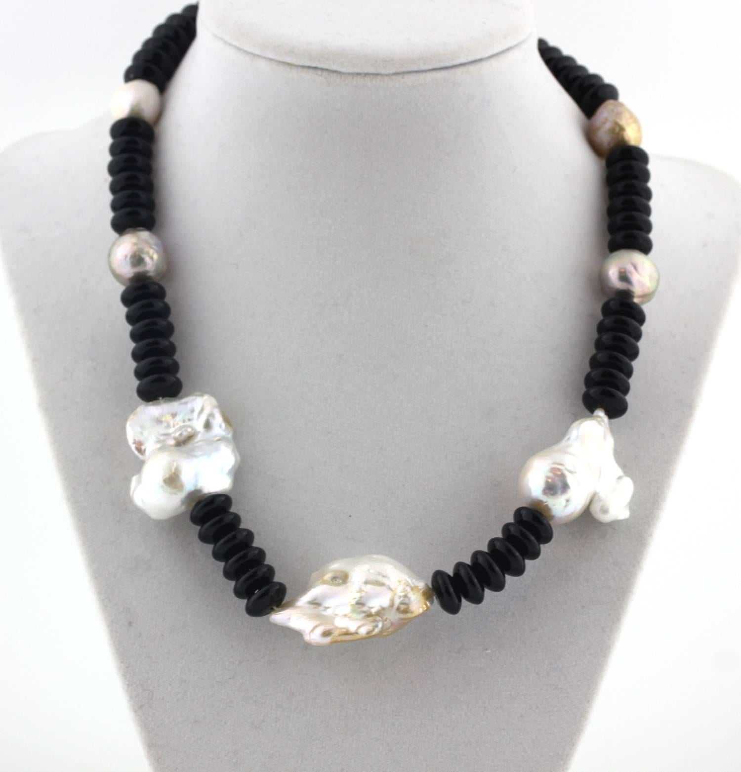 The super elegance of these beautiful silvery/platinum/white glowing Baroque Pearls is enhanced by the lovely gem cut and polished black natural Onyx rondels
Size:  largest Pearl 23 mm x 35 mm
Length:  18.25 inches
Clasp:  Pearl
