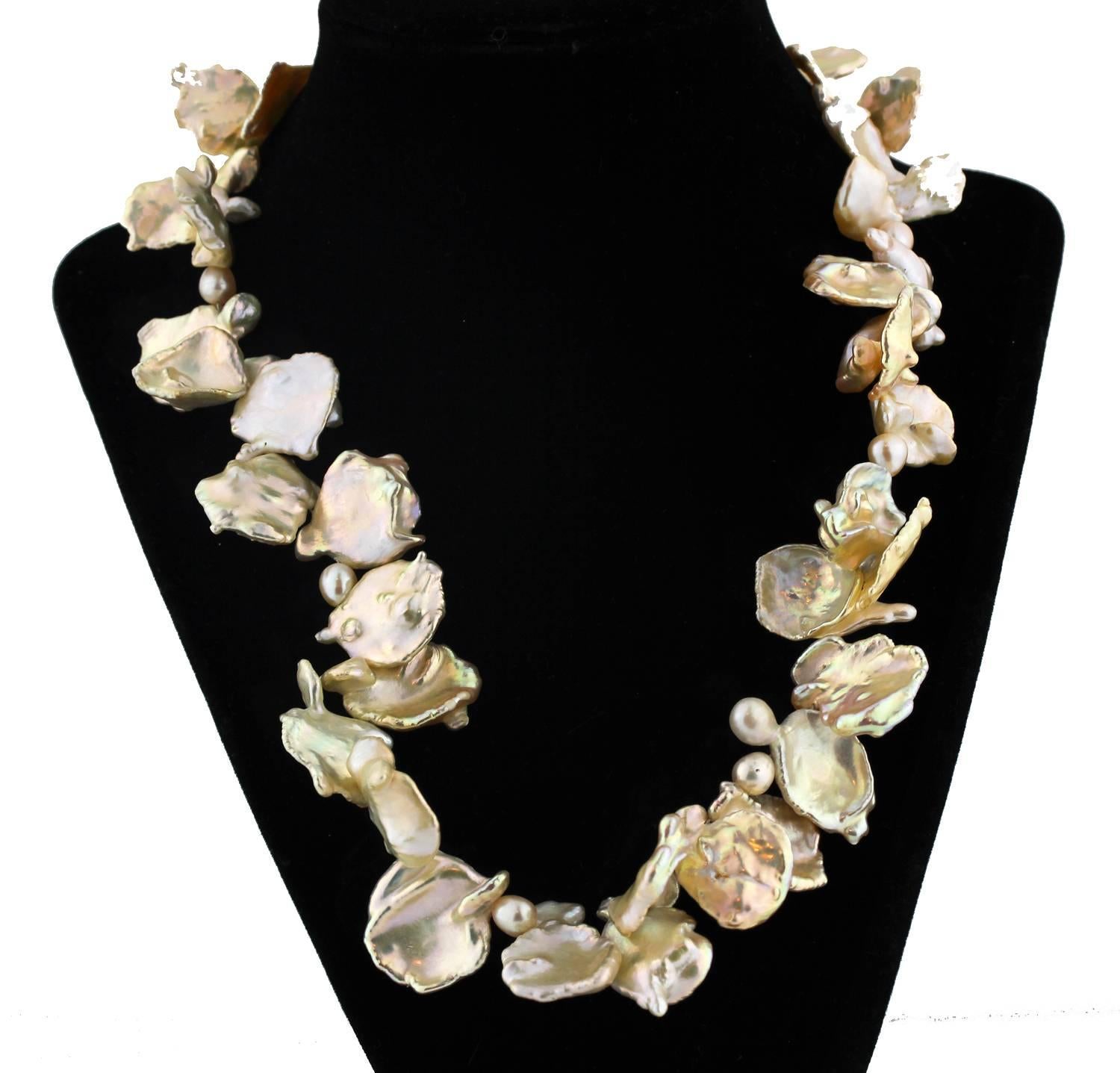 These Keshi Pearls enhanced, with smaller peanut Pearls, looks like a beautiful bouquet around your neck which you can arrange in many different looks when you put it on. 
Size:  up to approximately 27 mm
Length:  19.5 inches
Clasp:  gold plated