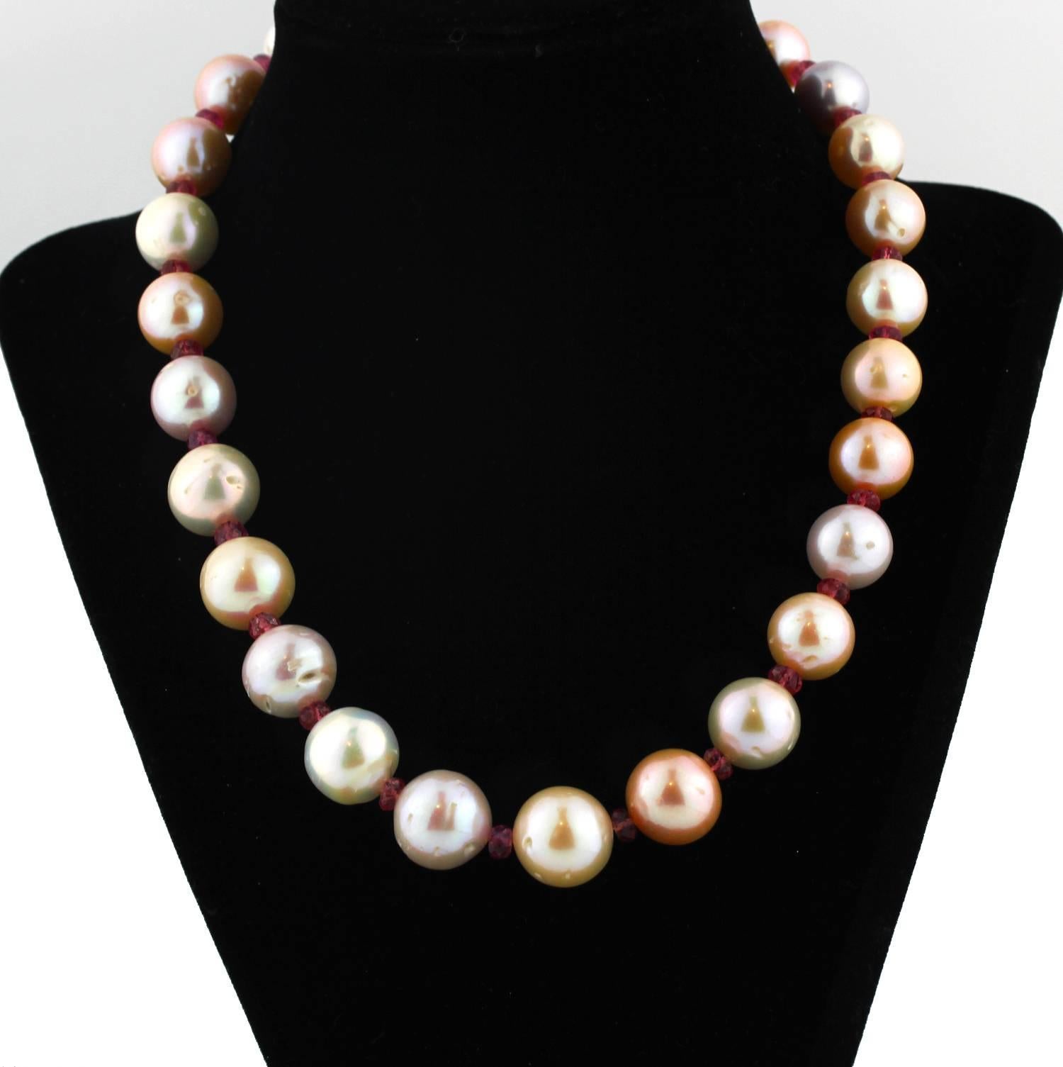 These slightly graduated  multi-color magnificent Pearls (some with their natural beauty marks visible) are enhanced with 29 gem cut sparkling natural pink Tourmalines in this unique handmade necklace.  Size:  largest Pearl 15.5 mm;  Length:  18