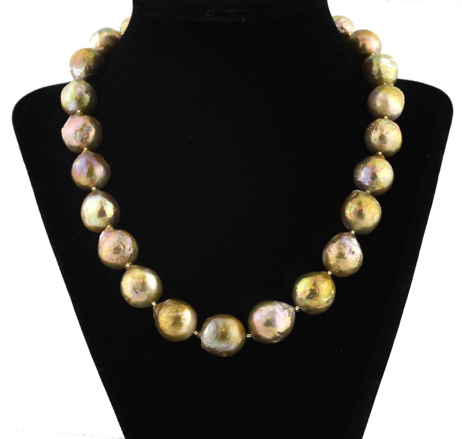 These are a spectacular combination of smooth and brilliant and wrinkled looking unique cultured Pearls with sparkling goldy crystal accents on this handmade necklace.  Size:  graduated up to 15.75 mm;  Length:  19 inches;  Clasp:  gold plated.  
