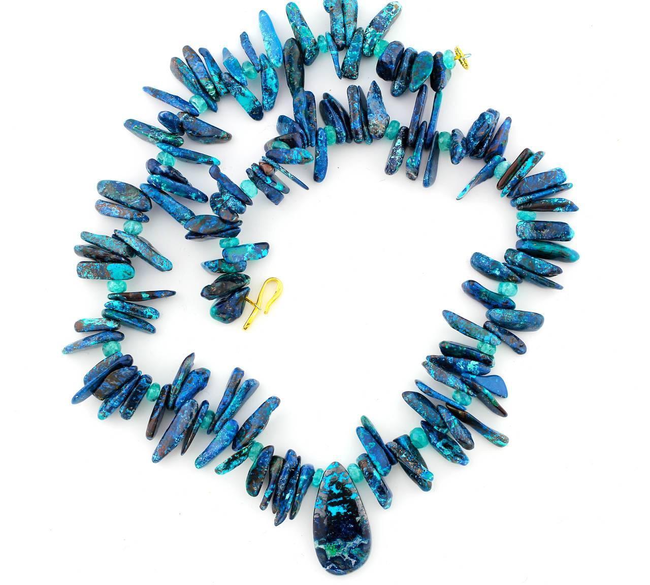 This natural slightly graduated Chrysocolla is highly polished  (practically glows in the dark!) and is accented with sparkling natural blue Brasilian Apatite
Size:  center pendant 37 mm x 20 mm
Length:  22.5 inches
Clasp:  vermeil (gold plated