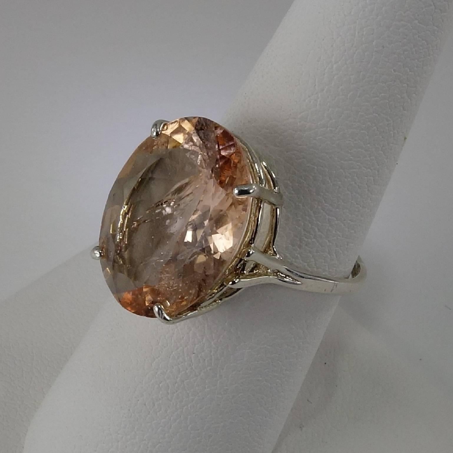 Sterling Silver Basket style ring holds a Sparkly peachy Morganite with all the delightful natural inclusions typical of a Morganite. The Morganite is 18mm x 14mm and approx 9.04ct. Size 8.5